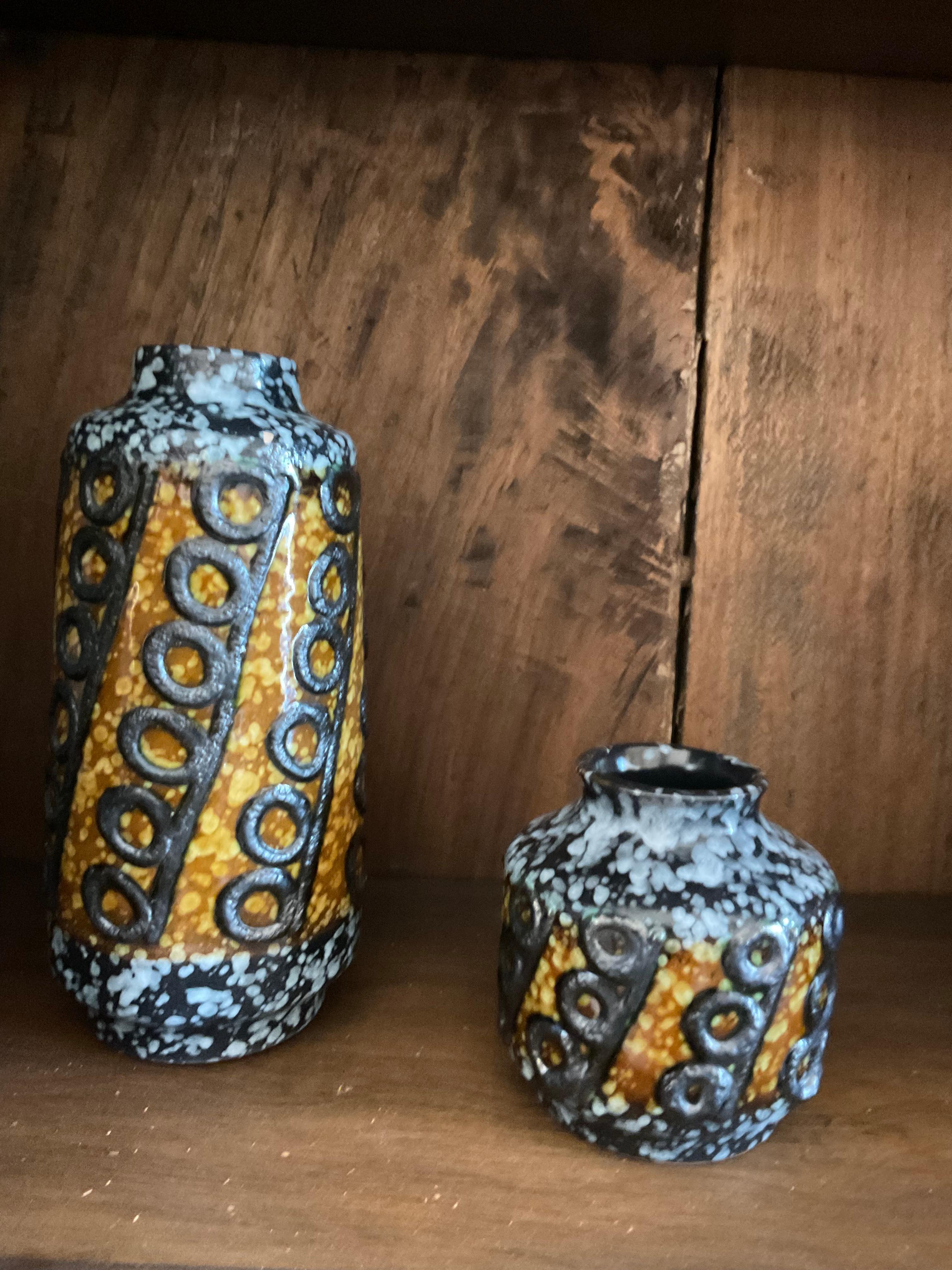 A set of five decorated and glazed vases with exceptional color and texture. Sizes vary from 3 -4.5 in diameter x 5-10.5 high.