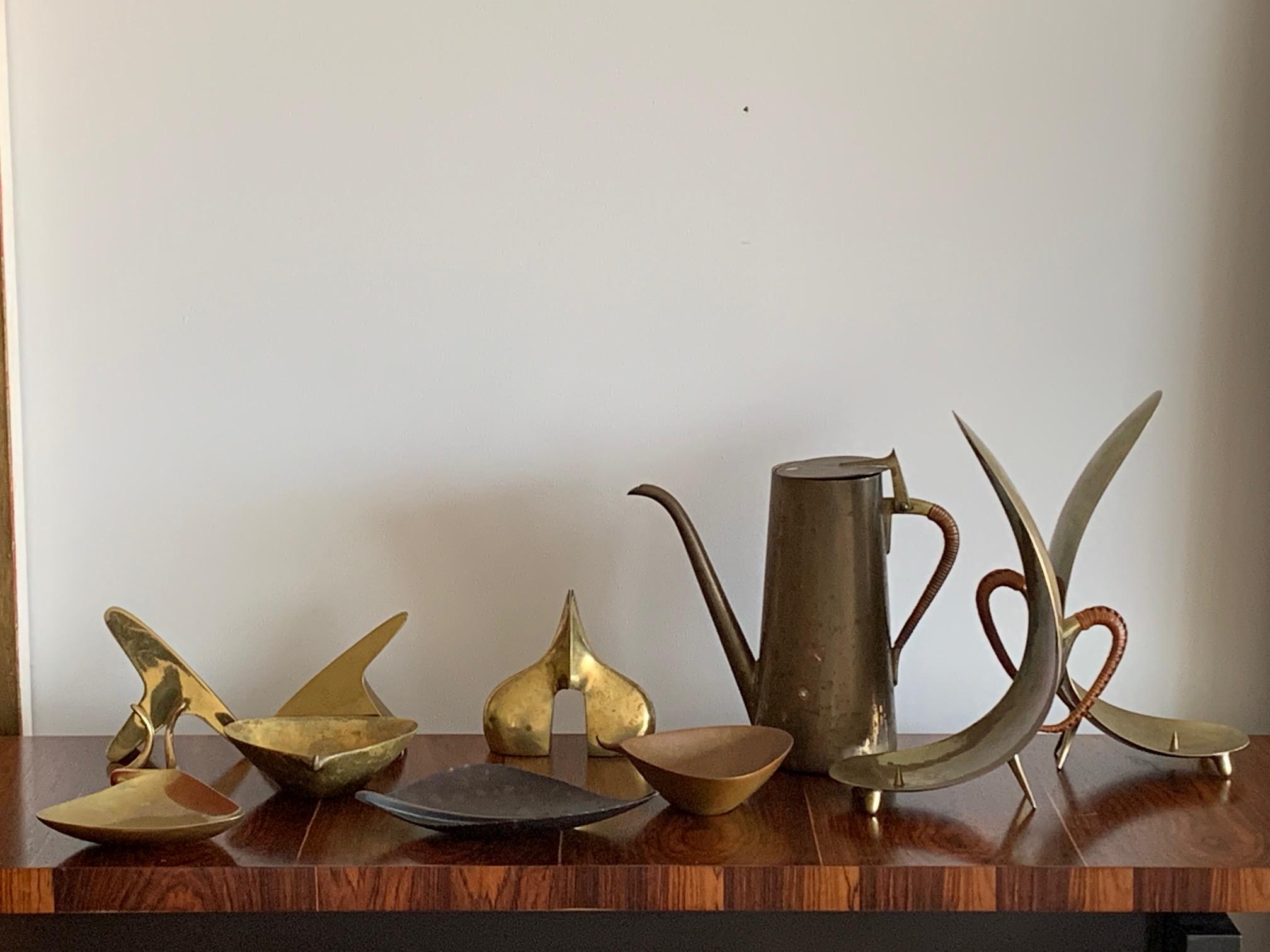 A collection of rare Carl Aubock vintage pieces. Total of twelve comprising of bowls, bookends, pitcher, most are signed.