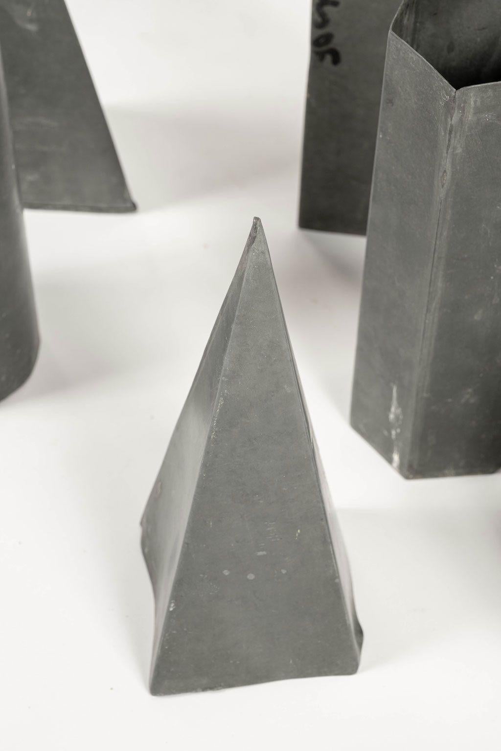 Collection of vintage geometric forms in zinc. Circa 1950-1979, Paris. Six pieces total or varying shapes and sizes. Sold together as a set priced $2,600.

Measurements:
Cylinder: H 10 in x DM 4 in
Pyramid: H 9.75 in x W 4 in x D 4 in
Prism: H 12 in