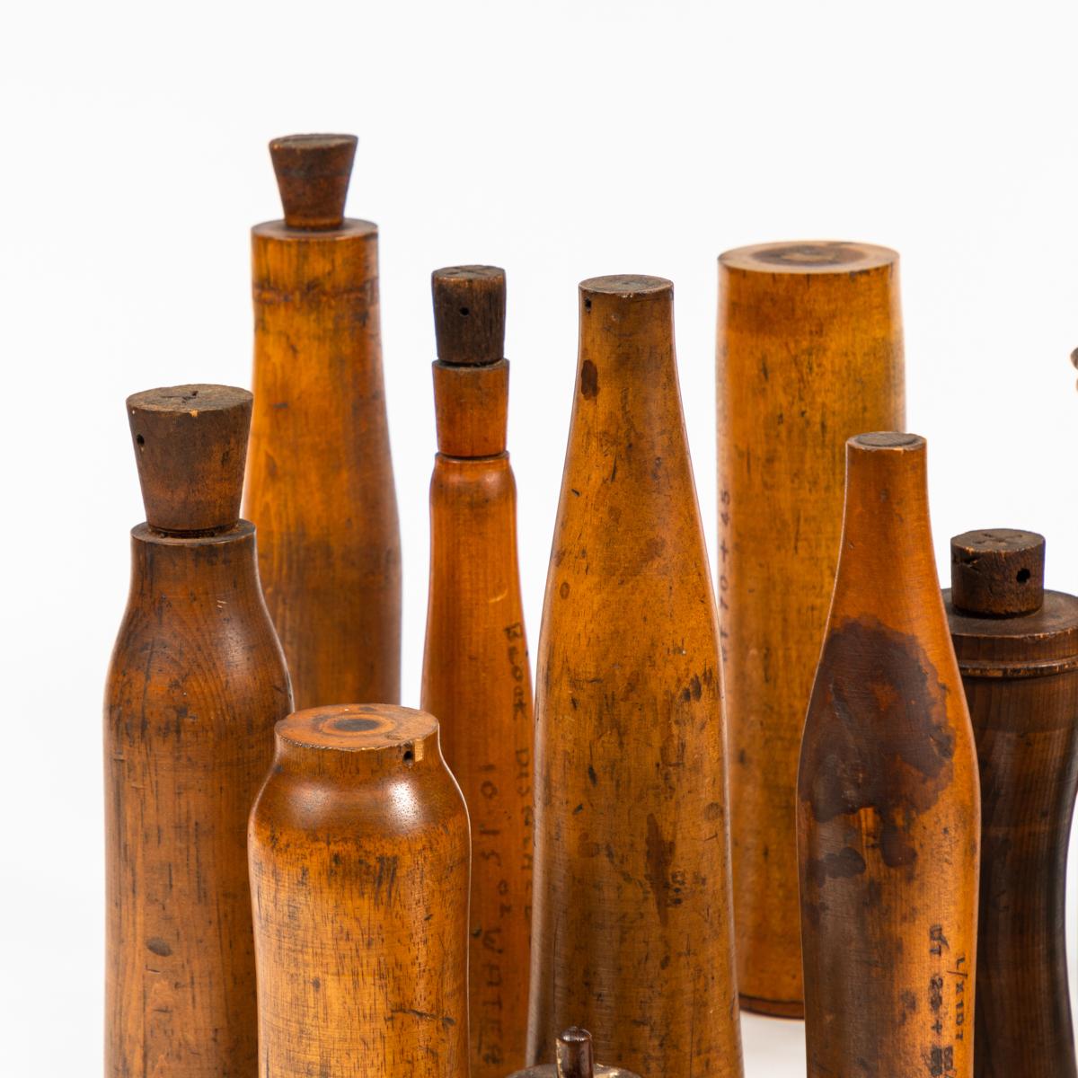 Collection of early 20th century wooden bottle molds from the John Lamb and Co. Glassworks in Castlelford, West Yorkshire. (13 pieces).