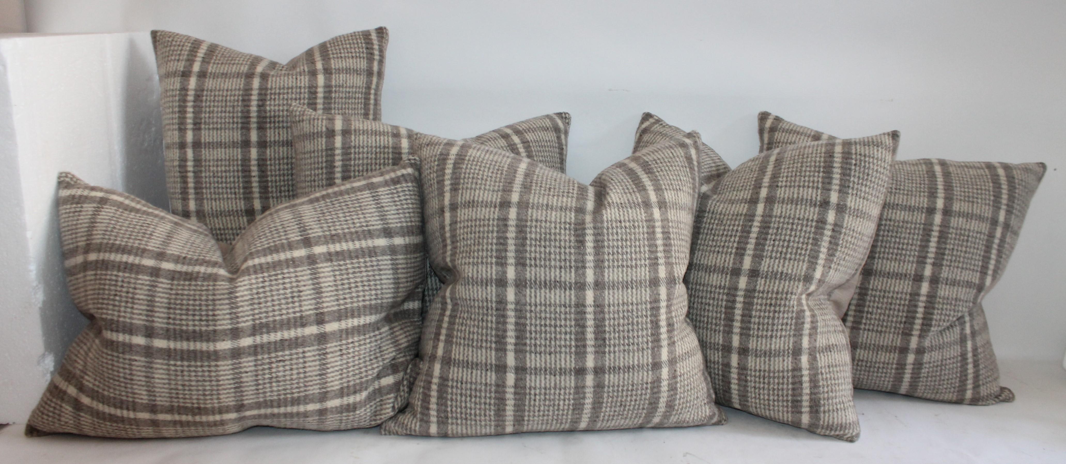 Collection of wool plaid pillows in pairs. Cotton linen backing on pillows. Three pairs of pillows. These are made from a handwoven poncho.