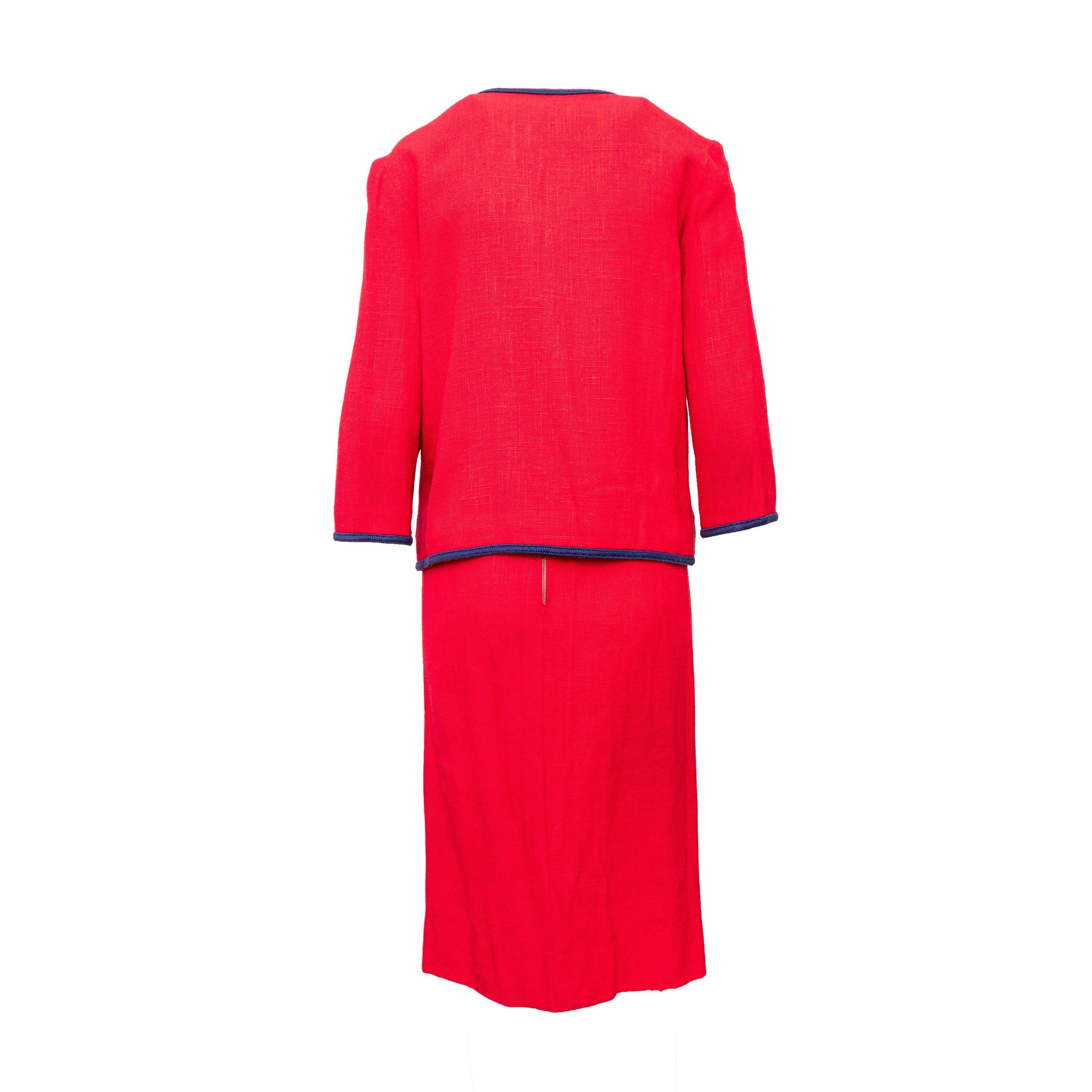 This vintage jacket and skirt set will add a touch of retro elegance to your wardrobe. Made from a high quality red wool blend fabric, the quarter sleeve jacket features blue thread trimmings and a zipper front closure. The unlined midi length skirt