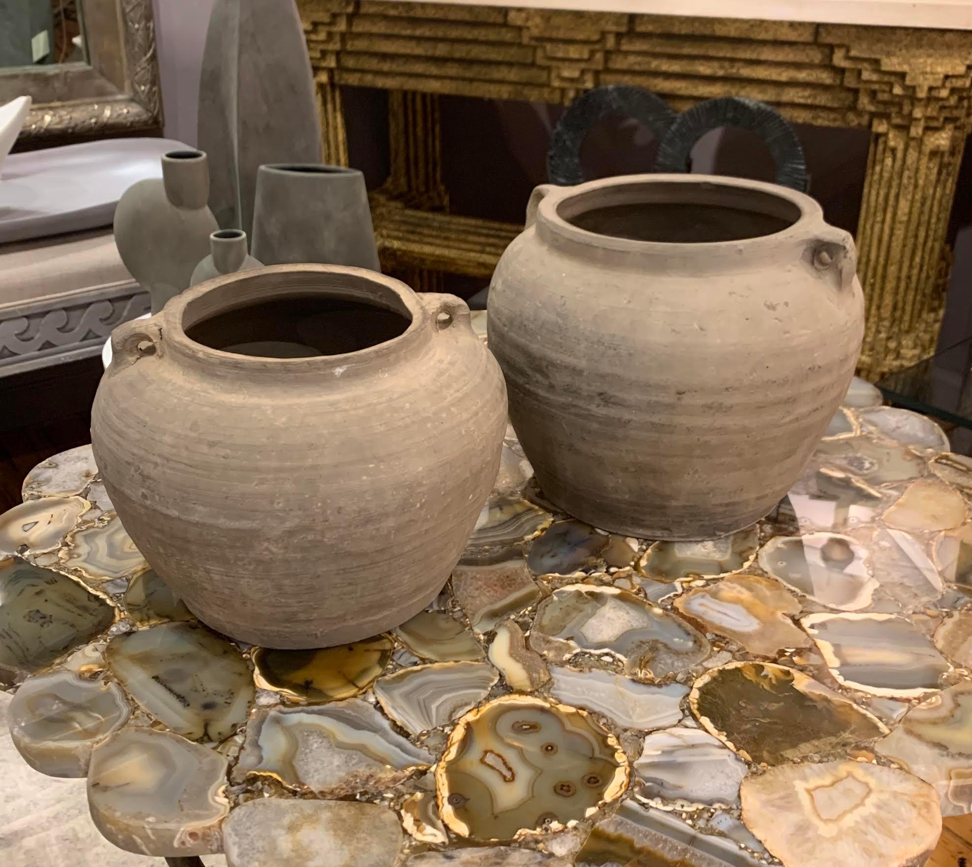 1940s Chinese collection of natural weathered patina terra cotta pots.
Two handled.
Horizontal ribbed and textured details.
Originally used to store and transport grains.
Sold individually
Sizes range 9.5