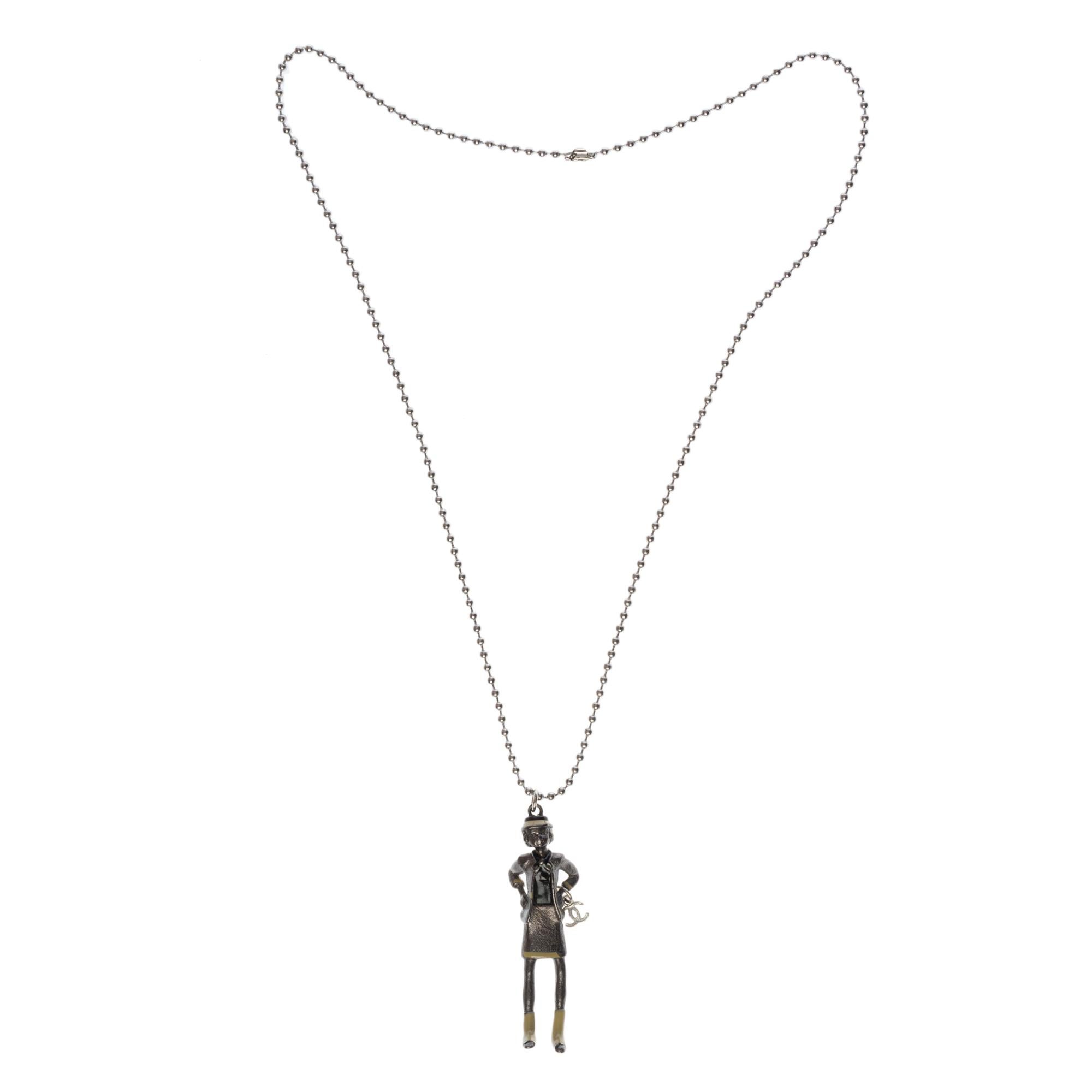 This adorable Coco Chanel Doll Necklace has only been offered to a few VIP customers as a special gift and has never been sold in Chanel stores.
You can use the Choco Chanel doll with a shorter silver metal chain as a charm for your bag or also as a