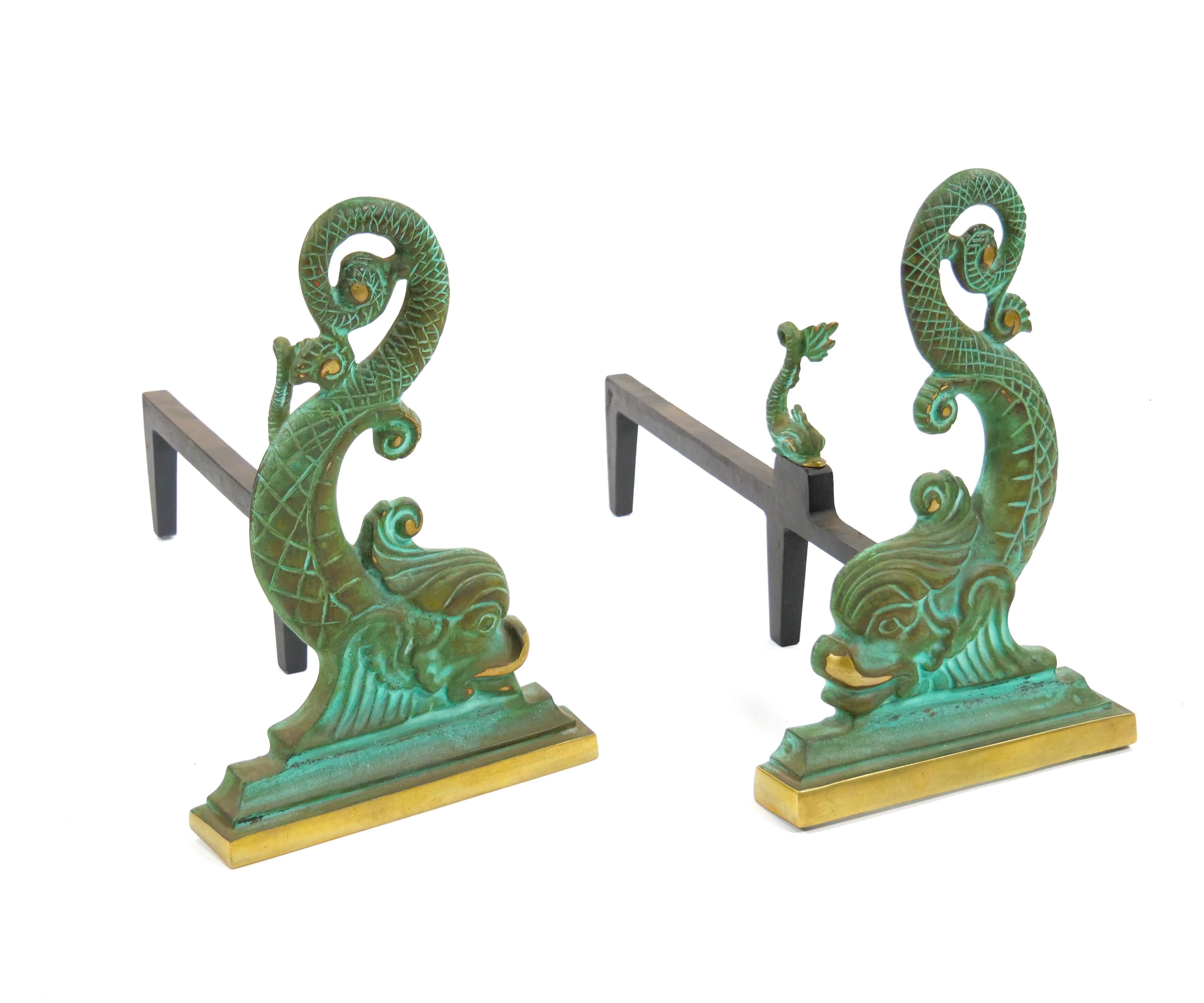 Add a touch of artistry and sophistication to your fireplace with this stunning pair of brass and wrought iron andirons, crafted in Italy in the early 20th century. Designed as a beautiful tribute to the graceful form of a dolphin, each andiron