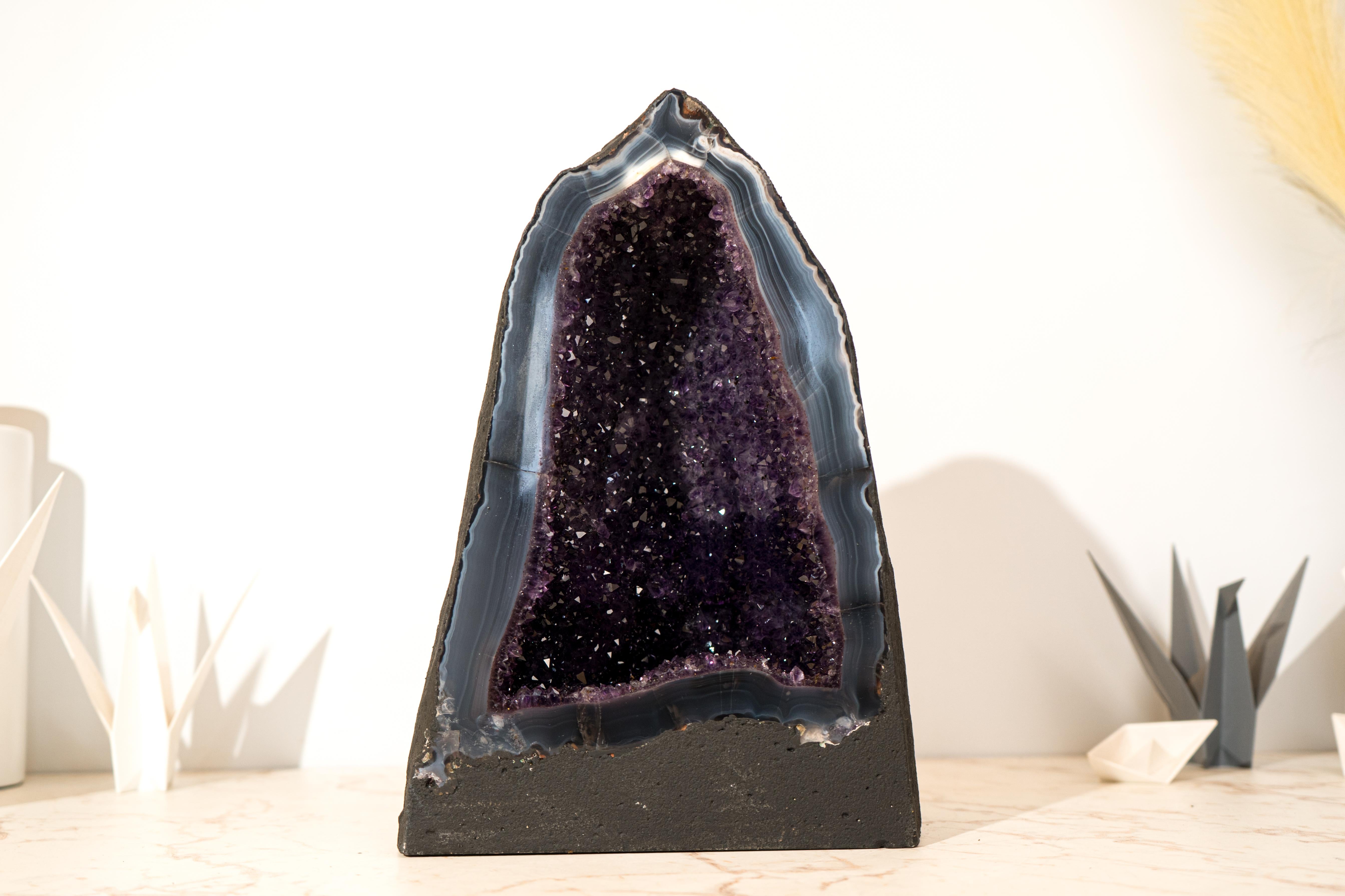 Gorgeous at first sight, this geode, composed of Amethyst on a Lace Agate matrix, showcases a rare and harmonious combination of colors, aesthetics, and pristine condition. Geodes of this caliber, particularly Brazilian geode cathedrals with such