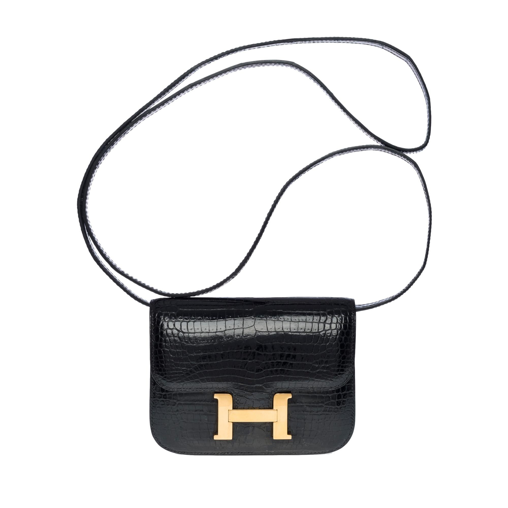 Rare Hermès Clutch Micro Constance in black porosus crocodile, gold plated metal hardware, removable black crocodile shoulder strap compatible added (not from Hermès) for hand, shoulder or crossbody carry

Zipper on flap
Black leather lining, one