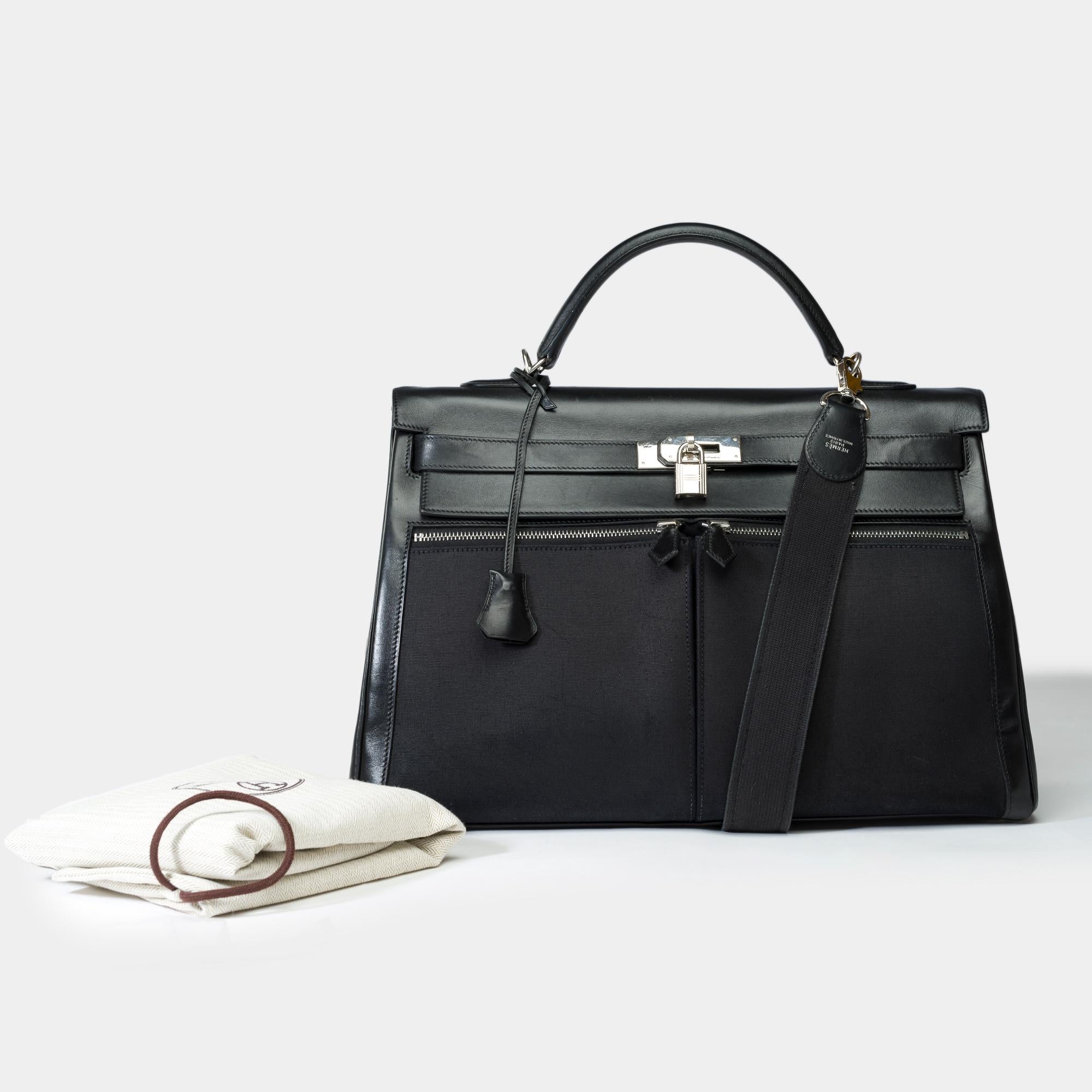 Rare​ ​Hermes​ ​Kelly​ ​Lakis​ ​40​ ​handbag​ ​strap​ ​in​ ​black​ ​Swift​ ​leather​ ​and​ ​black​ ​canvas,​ ​palladium​ ​silver​ ​metal​ ​trim,​ ​black​ ​leather​ ​handle,​ ​a​ ​black​ ​leather​ ​handle​ ​for​ ​hand​ ​or​ ​shoulder​ ​carry

A​