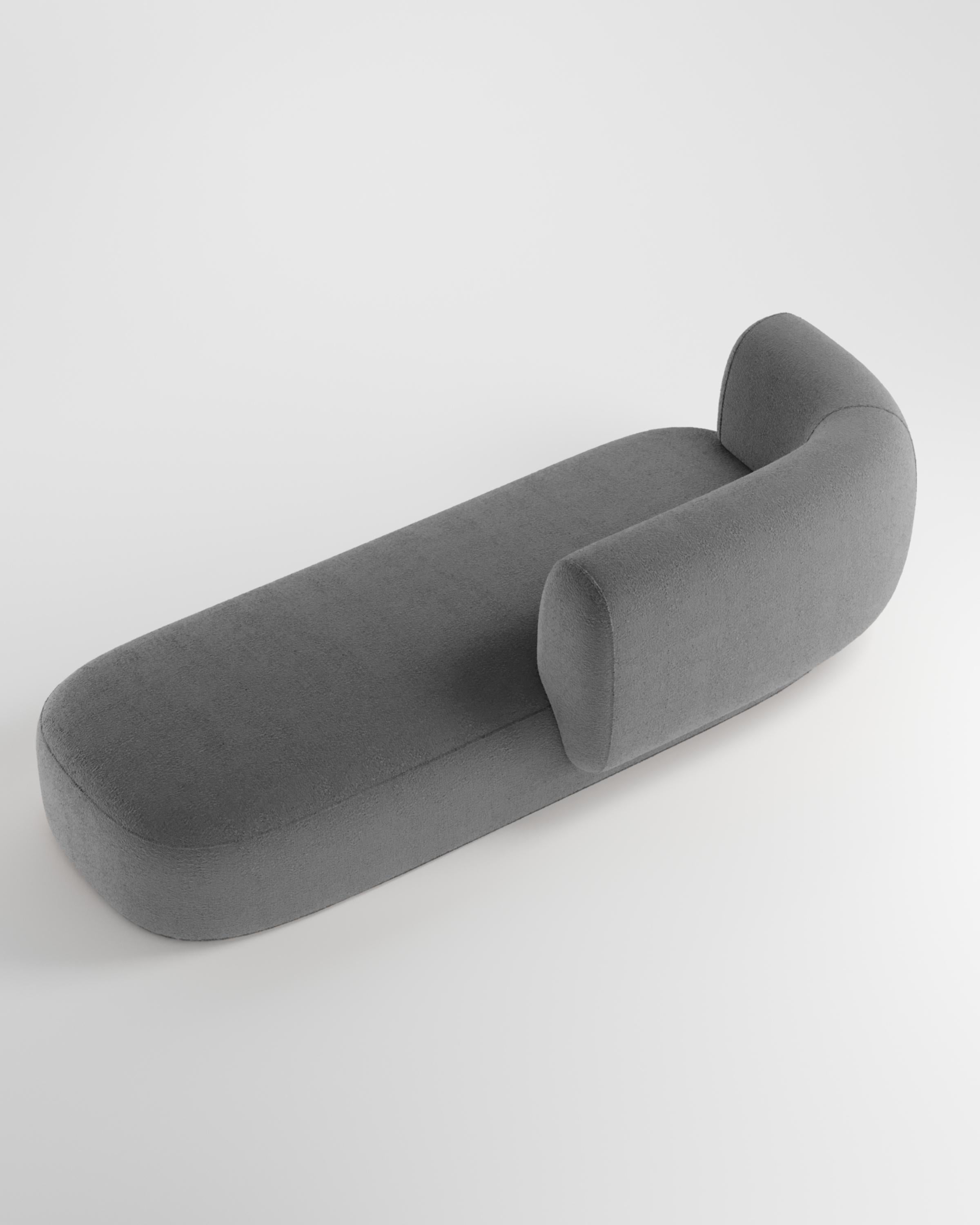 Hug sofa is defined by clean, simple lines and a distinctive armrest detail.
The armrest, half overlapping the seat cushion, creates an interlocking detail between the two elements, while the padding, firm and welcoming at the same time,