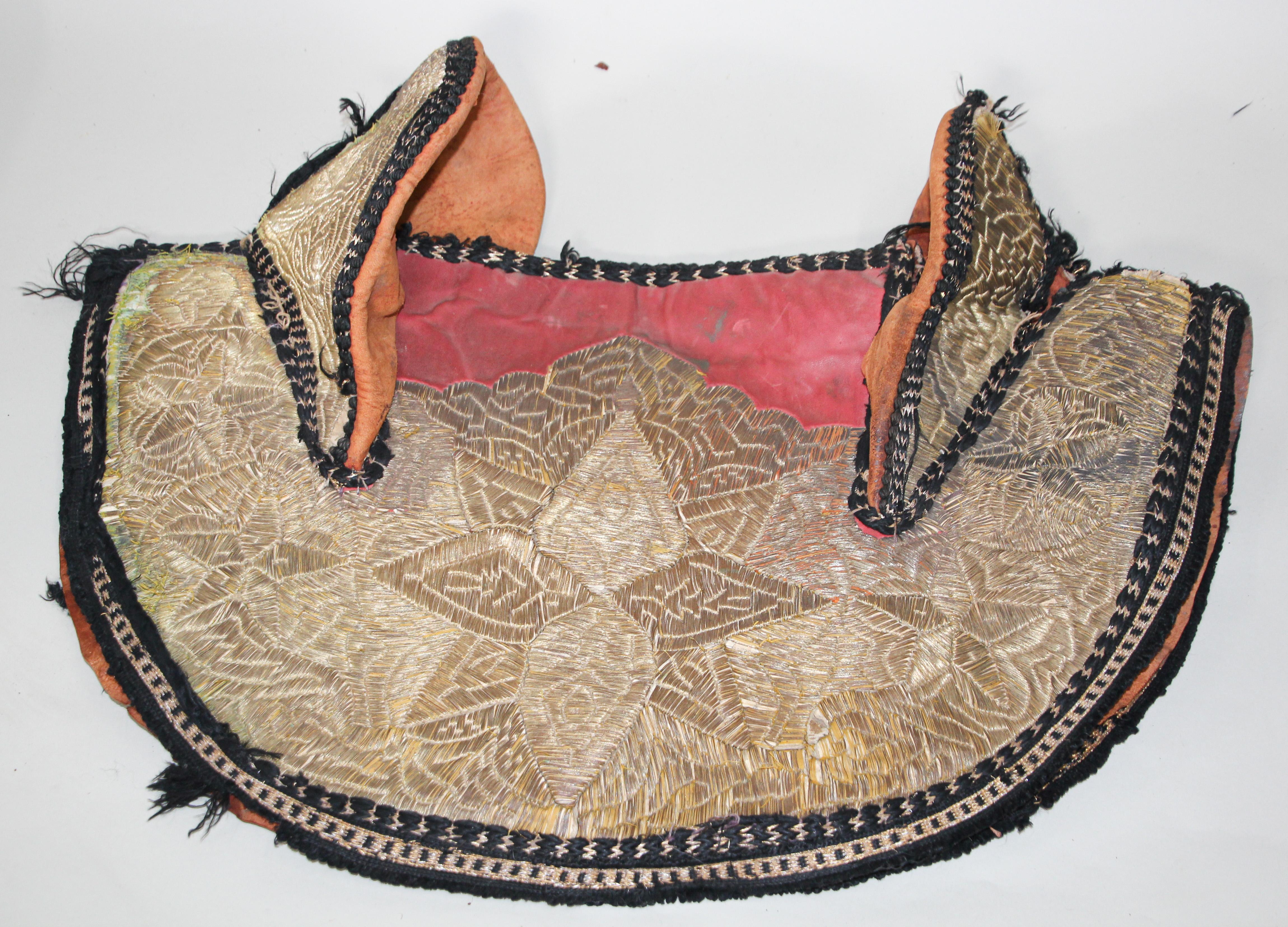 Handcrafted Moroccan horse saddle cover made for a ceremonial Festival and shows. Elaborately embroidered overall in gold threads, comprising of a saddle cover, the central section of the saddle pad and backing is made of red leather.
Heavily