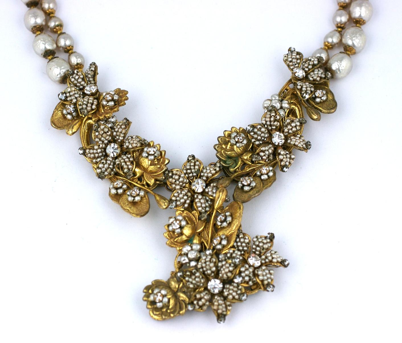 Magnificent, large Miriam Haskell necklace of signature faux pearl micro beaded flower heads set on bases of water lilies and lily pads in Haskell's signature Russian gilt metal. Early necklace with elaborate craftsmanship from the 1930's. The links
