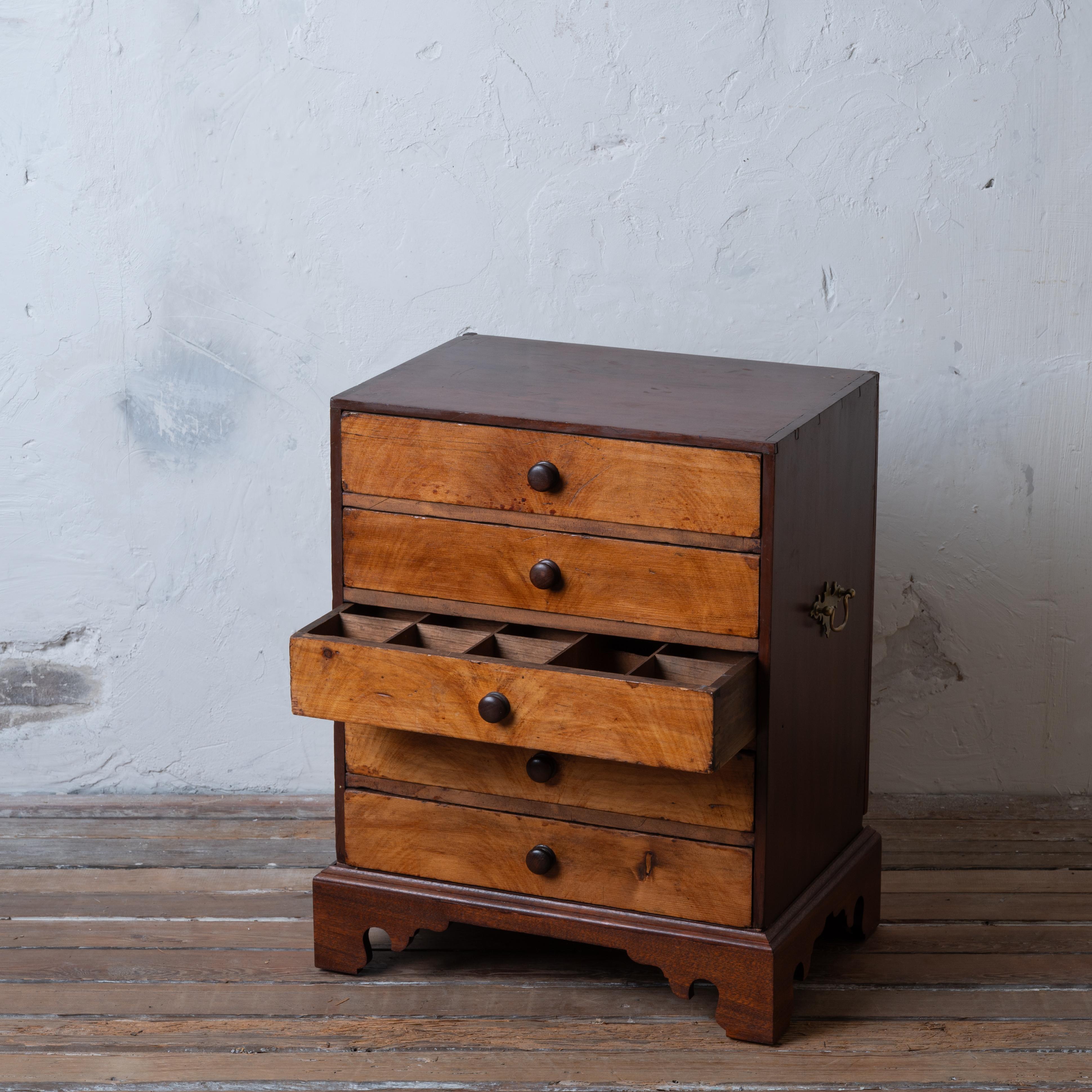 A small collectors or apothecary chest with divided drawers, 19th century.

Composed of walnut and grain-painted pine with later mahogany chippendale bracket feet.  Each drawer has dividers with the exception of the bottom drawer. 

22 ¾ inches wide