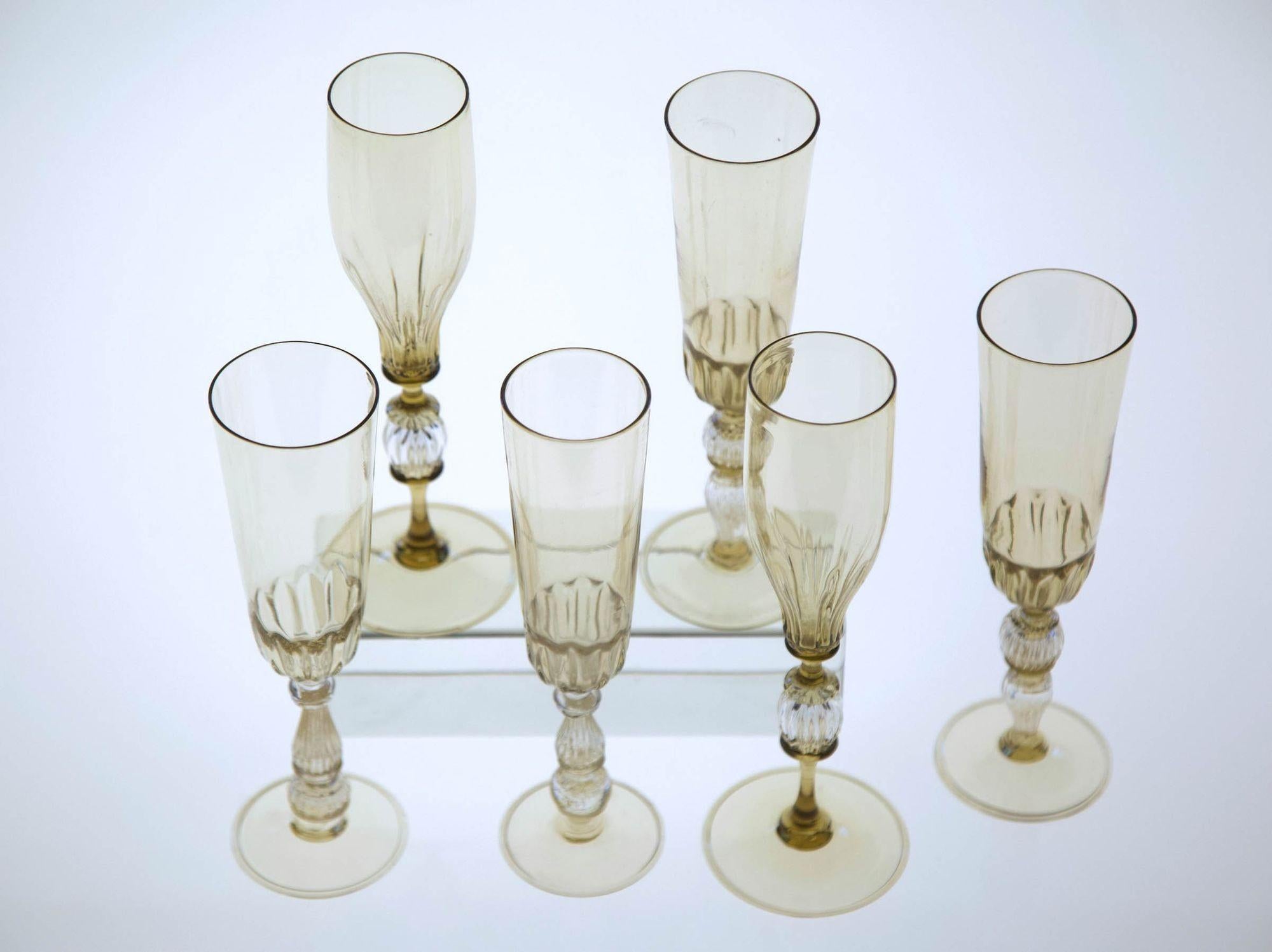From the Cenedese personal collection. Here a set of 6 stem glass made in 3 different designs.
All in light fume.
This group is absolutely unique and would become the focus of a table set or make three set pairs of flute. There is a special