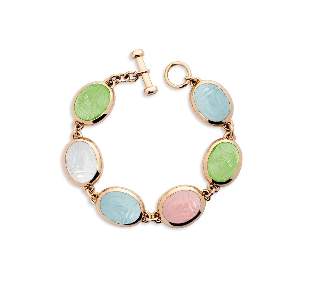 This very beautiful Scarab Bracelet in 18 carat rose gold with 2 aquamarines 30.69 ct, 2 prehnite 27.82 ct, 1 rose quartz 15.19 ct and 1 milk quartz 15.00 ct. In old Egypt the scarab was a symbol for resurrection and life and since that time a lucky