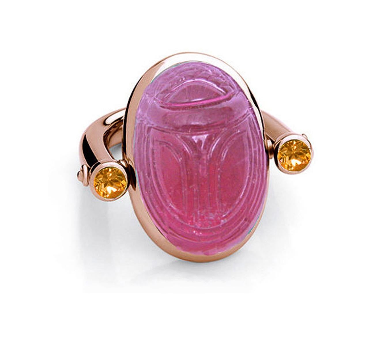 In old Egypt the scarab was a symbol for resurrection and life and since that time a lucky charm for everyone. This desirable ring with one rubelite 30,58 ct and two orange sapphires 0.77 ct could be your personal lucky charm.