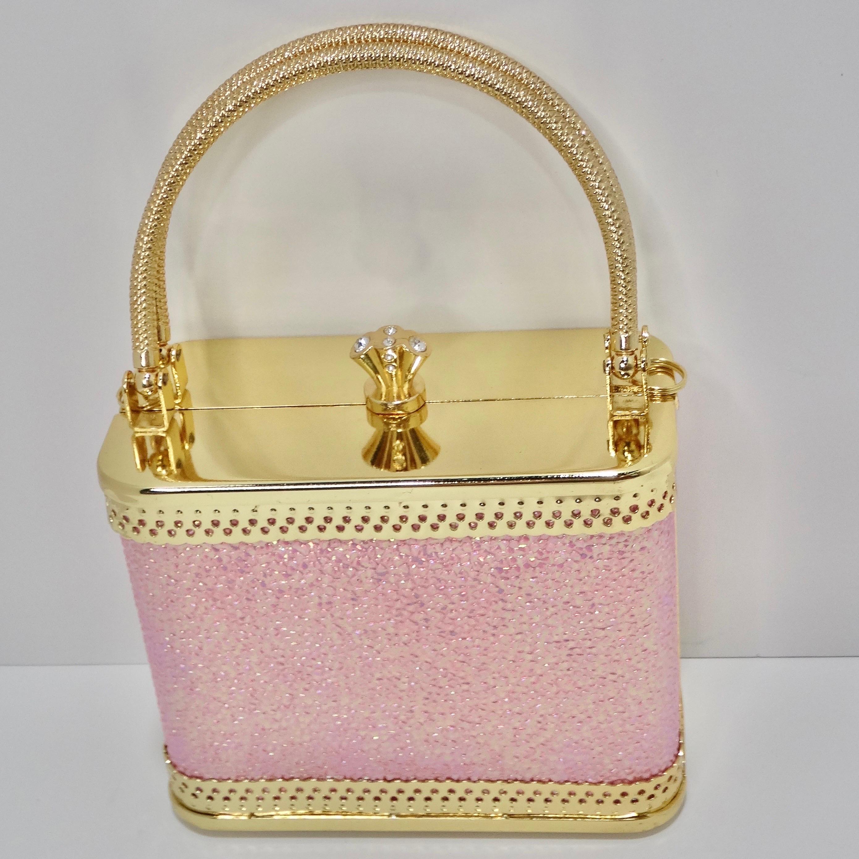 How adorable is this Colleen Lopez pink glitter mini handbag?! The perfect playful going out accessory to complete your look, this minaudiere style clutch features plated gold contrasting and eye catching sparkly pink. The bag features 2 structured
