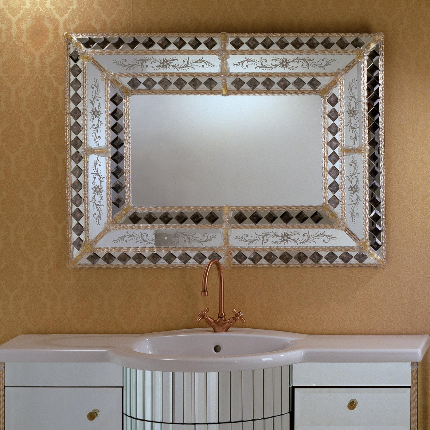 Painstakingly handcrafted by master glassmakers following traditional techniques, this opulent mirror will splendidly complement a classic console or bathroom. The wide frame in mirrored glass is accented with golden flowers in Murano glass