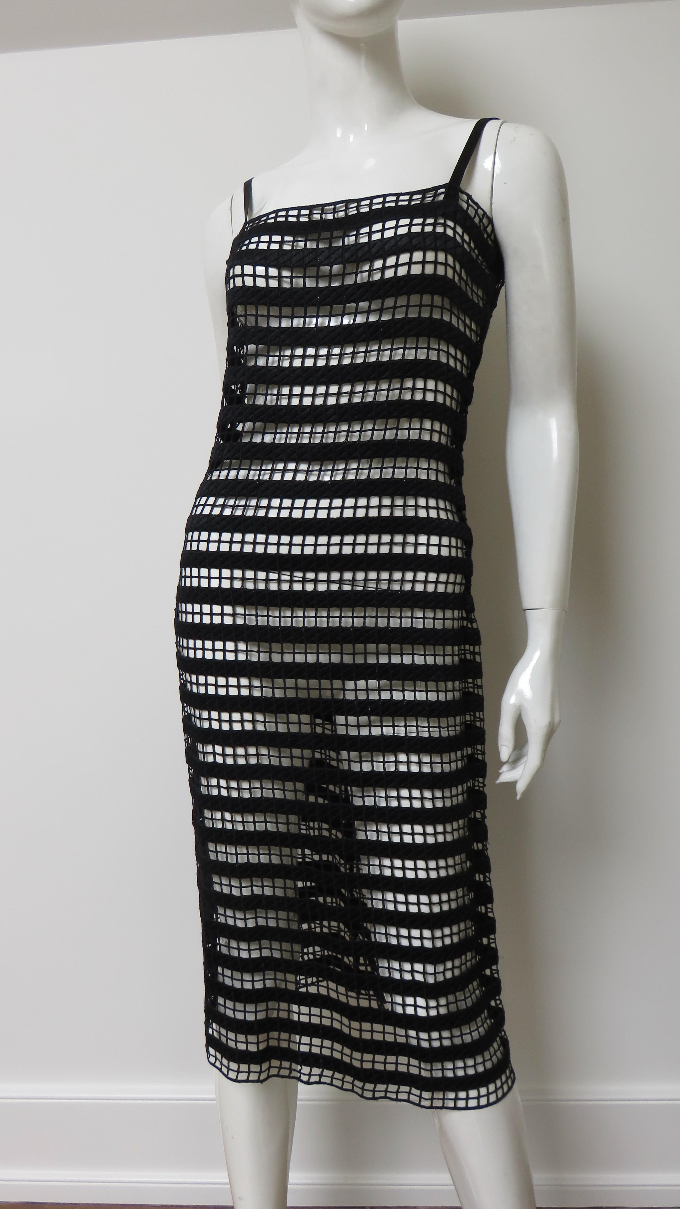 A stunning black silk dress in a linear geometric pattern by Collette Dinnigan.  It is a slip style dress with black straps and rows of horizontal lines joined by rows of faggoting or decorative stitching skimming the body to the hem. Very