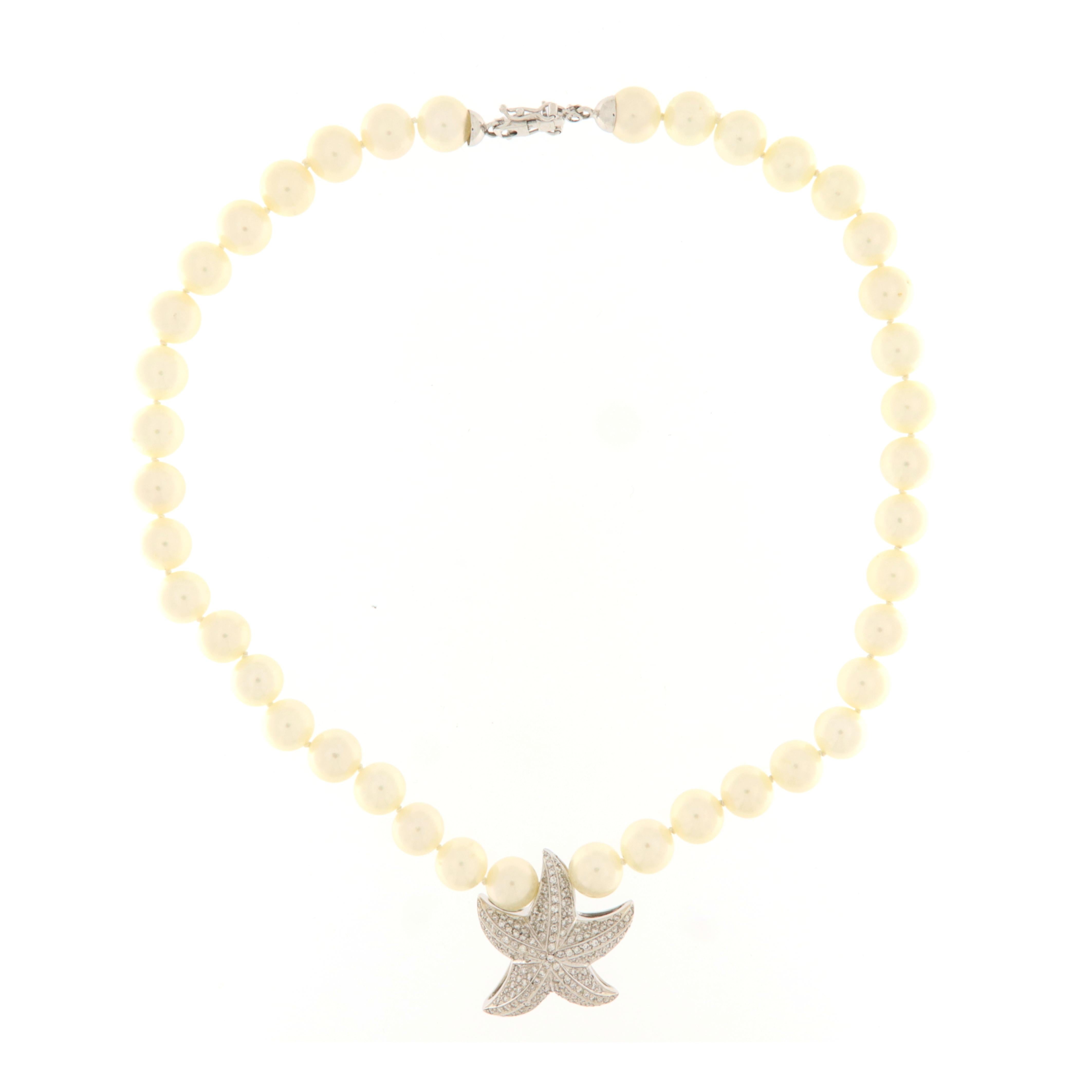 Necklace with 8 mm. white pearls with central element starfish in white gold and brilliants (ct.2.20). White gold and diamond clasp. 
