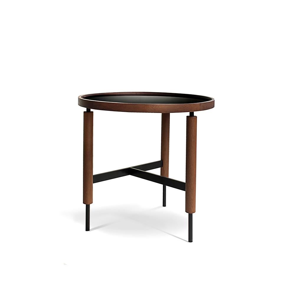 Collin side table by Collector
Materials: Table top in black ultra-compact glass with an oak frame. Legs in oak with black lacquer metal details.
Dimensions: Ø 50 cm H 50 cm

The Collector brand aims to be part of the daily life by fusing