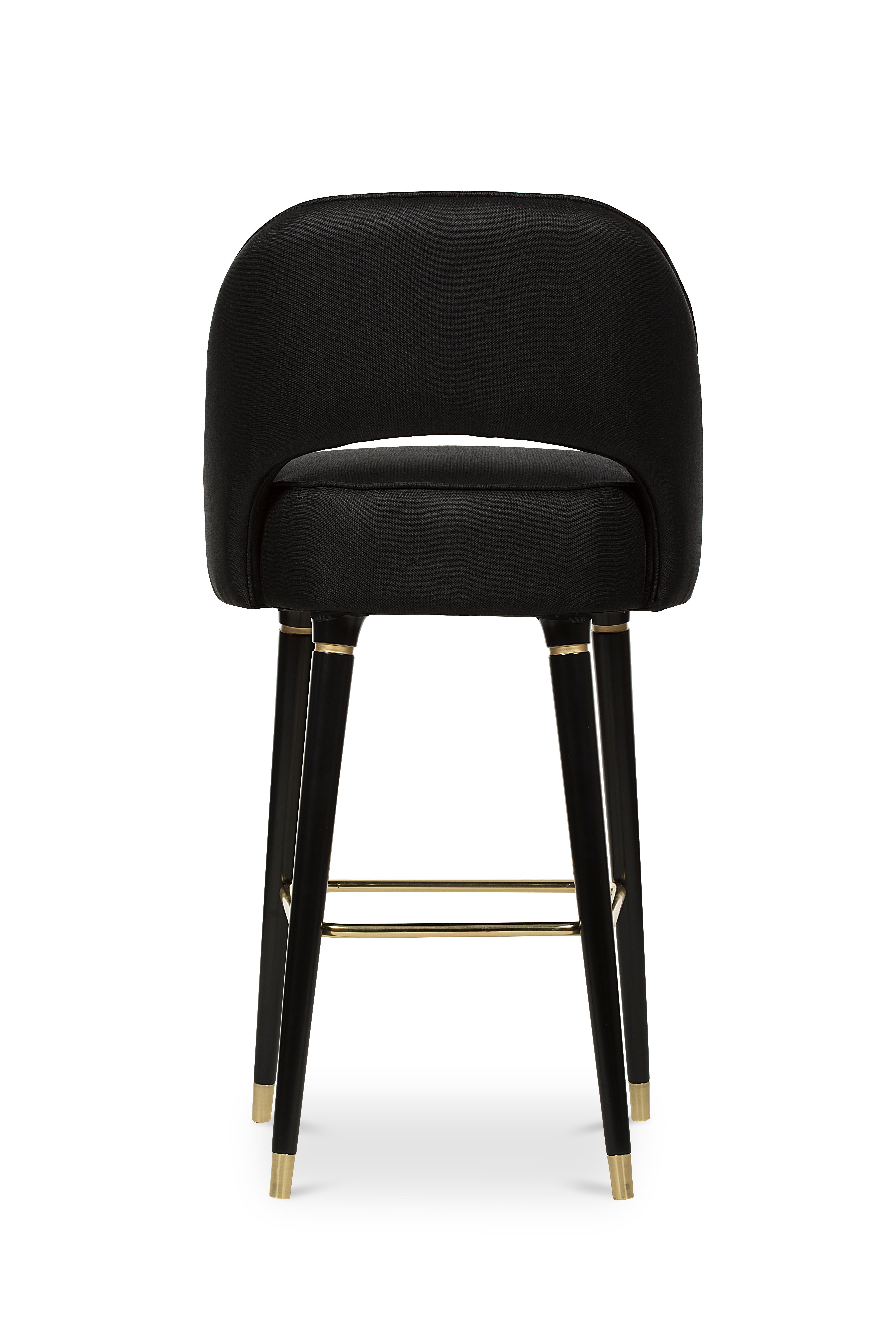 Collins is an open back chair with sleek lines and subtle details. The glamorous glossy legs accented with polished brass tips give this piece its mid-century modern touch. Collins Bar Chair sets up a luxurious statement in home furnishings. Set the