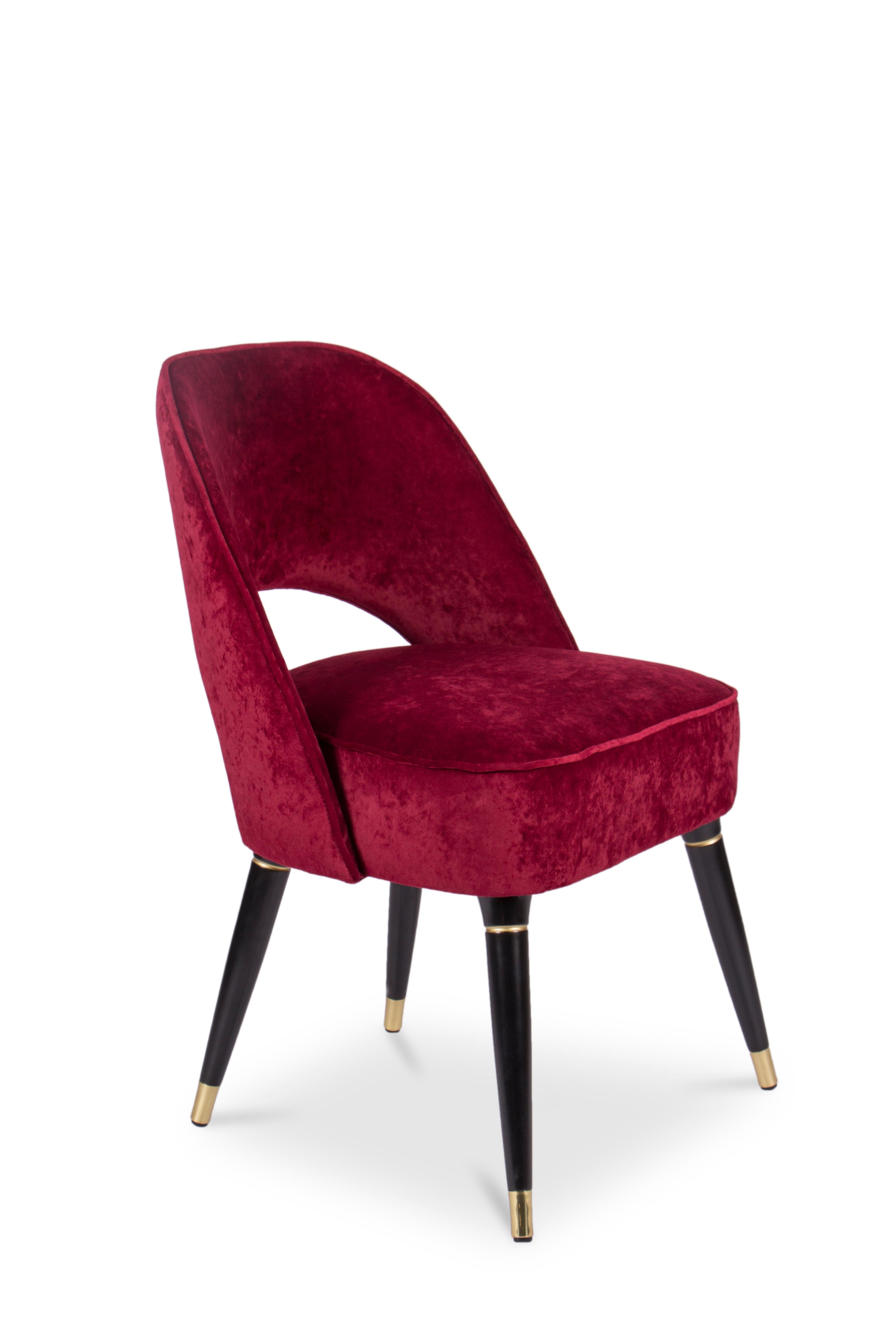 Mid-Century Modern Collins Red Velvet Dining Chair by Essential Home

Mid-Century Modern Collins Red Velvet Dining Chair is upholstered in velvet, supported by tapered glossy black legs with rich accents of polished brass. It has welted stitches on