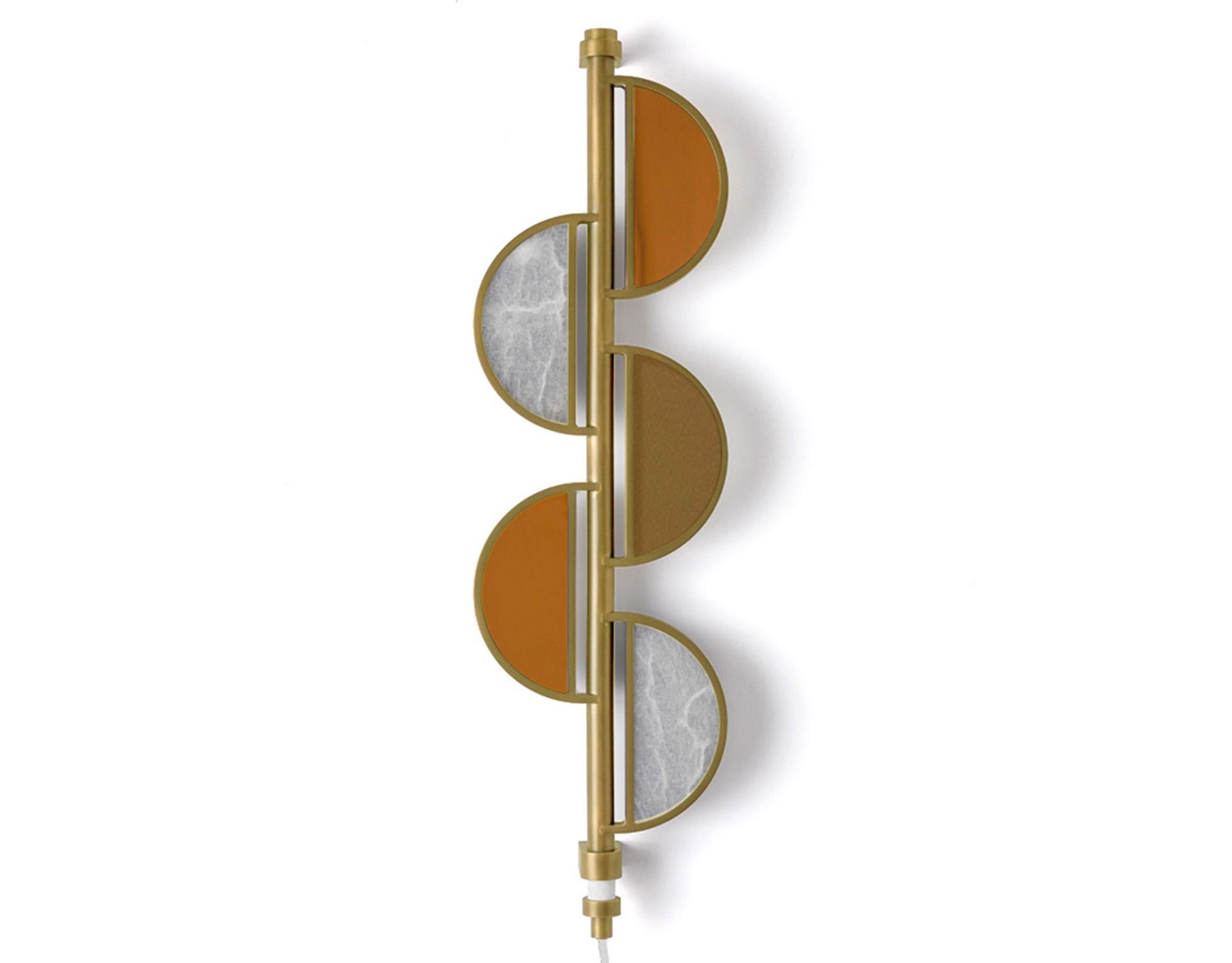 A beguiling bench-made fixture, oil-rubbed brass frames a quintet of hemispheric panes—sunset bronze-glass, iridescent alabaster, and smoke-mirror glass. Further setting this sconce apart is the gorgeous materiality of the hand-worked metal, its