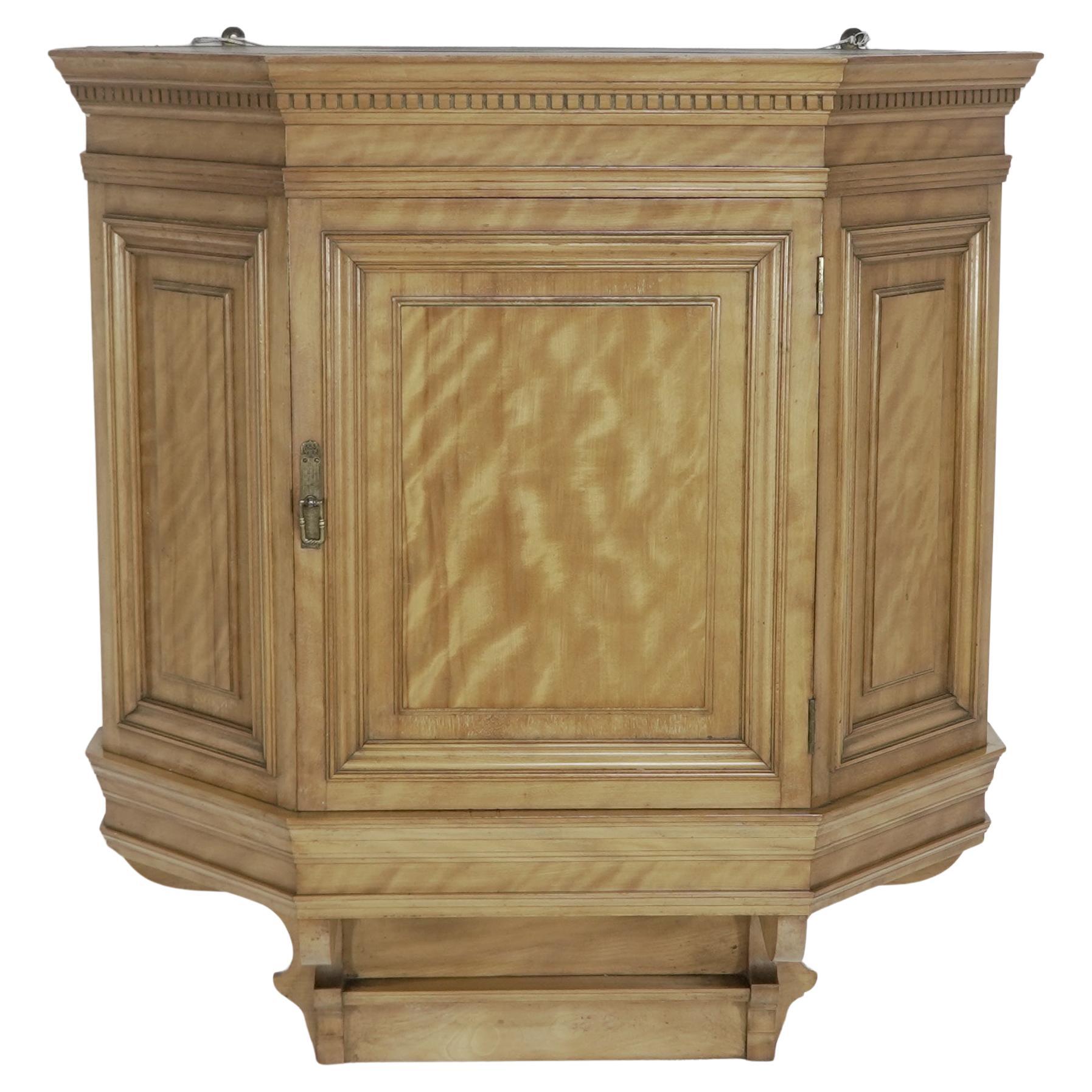 Collinson and Lock. An Aesthetic Movement Satin walnut breakfront wall cupboard For Sale