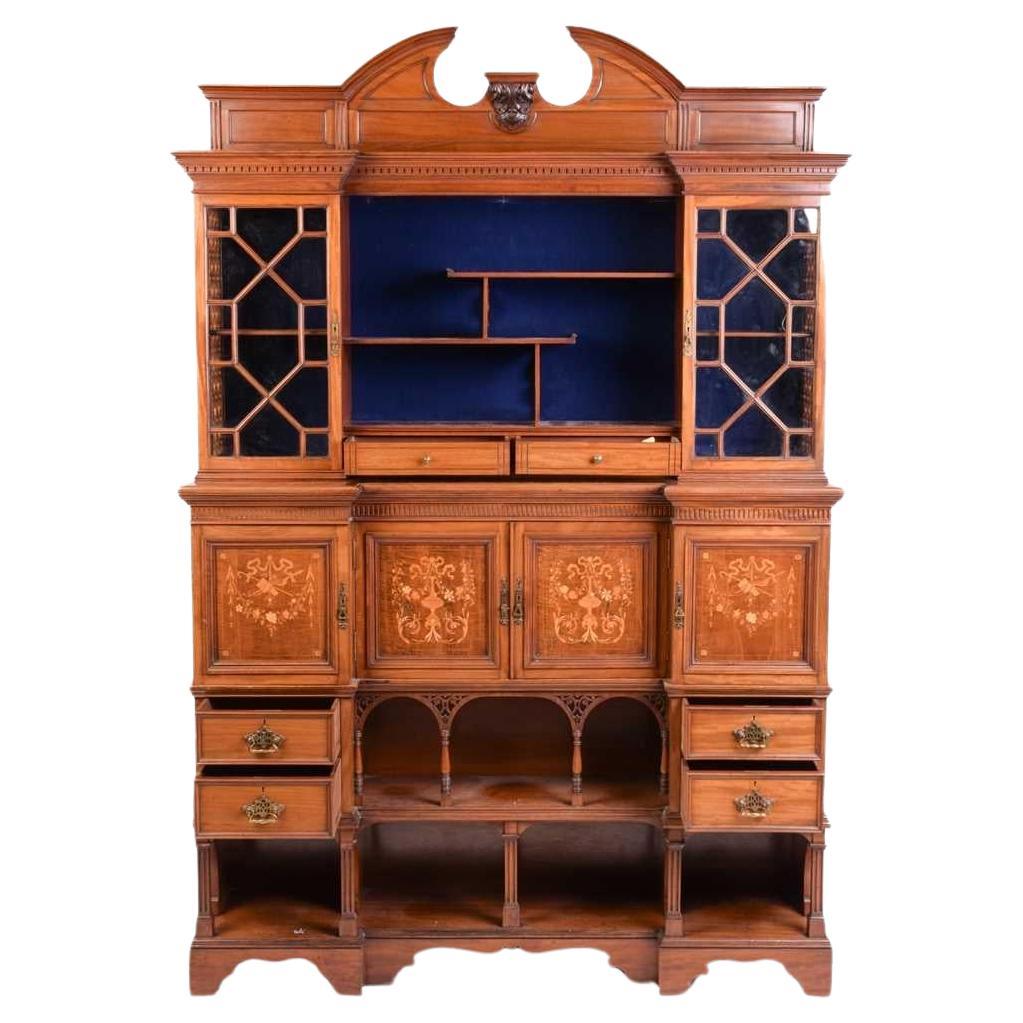 An Anglo-Japanese inverted mahogany sideboard, the arched open cornice with a small central carved display bracket to the centre, and an upper display shelf, a dentil cornice below with Japanese shelves to the centre above two small drawers, flanked
