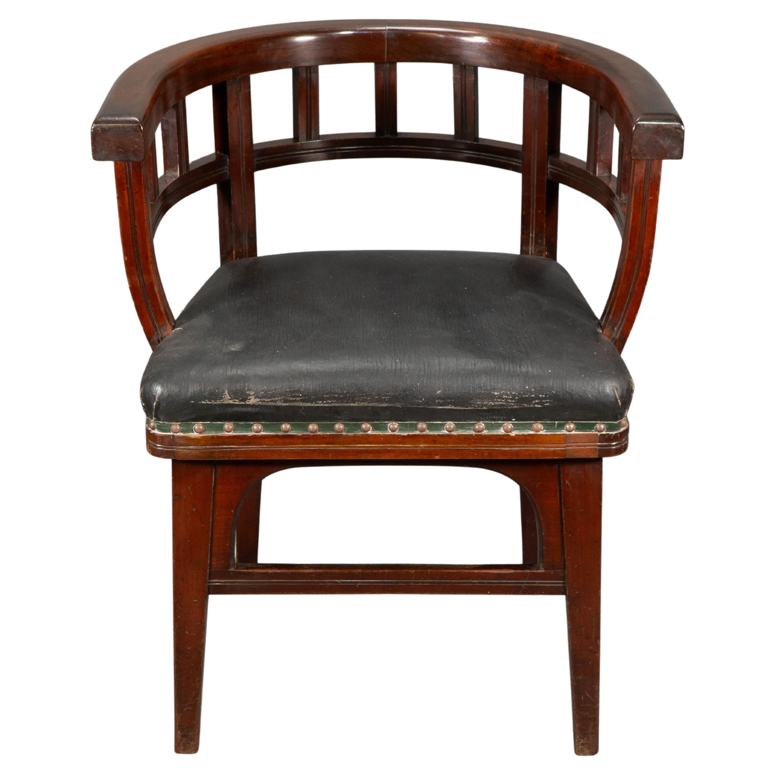Collinson and Lock, attributed. An Aesthetic Movement Walnut armchair with double shaped back and arm rail. The seat sits slightly proud of the tapering legs to allow for the decorative arched supports that meet the stretchers, with subtle incised