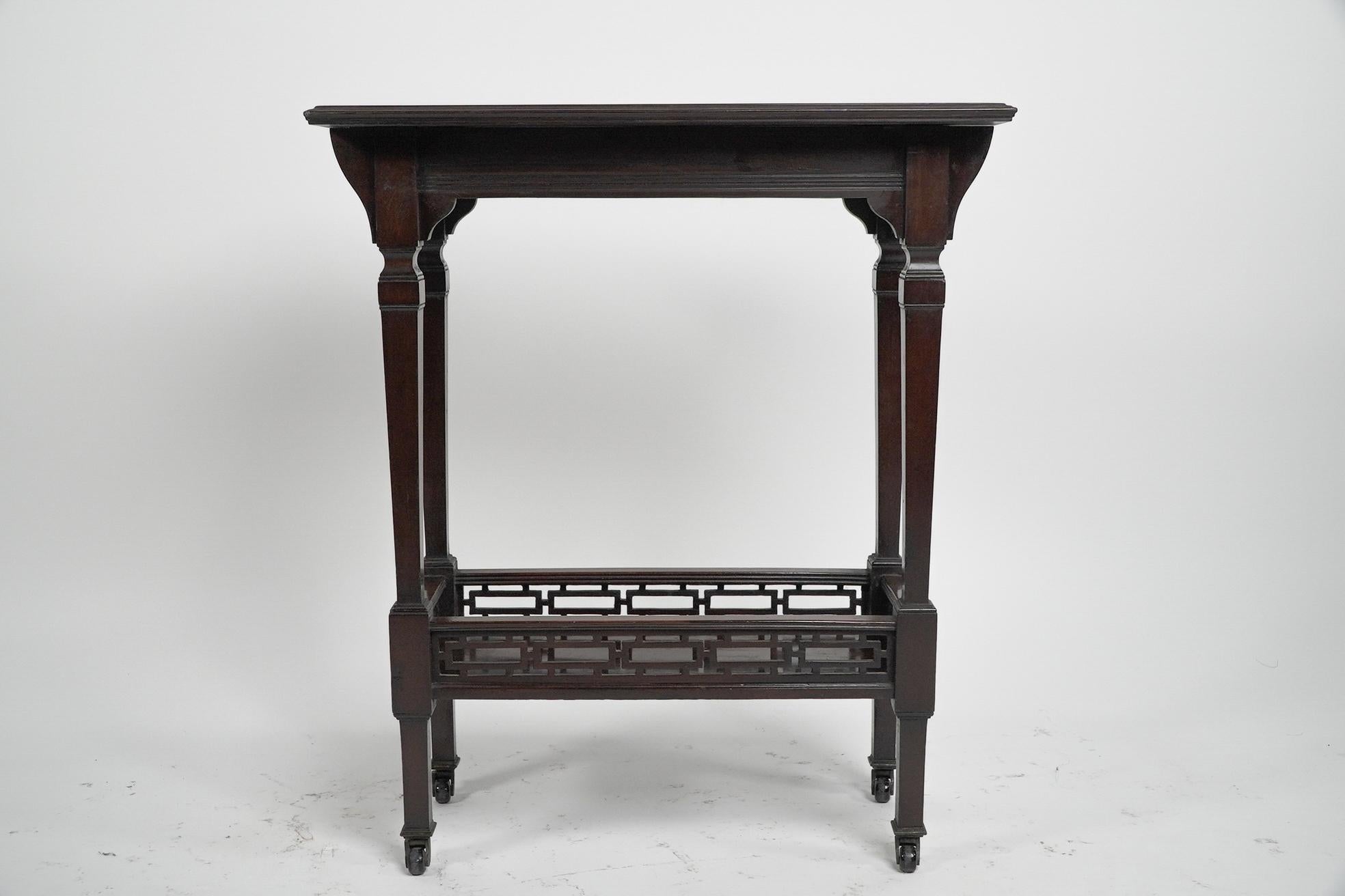 Collinson & Lock Attributed. A small Aesthetic Movement Mahogany side table with raised Japanese fretwork to the lower shelf.