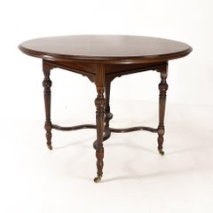 Collinson & Lock attributed. An Aesthetic Movement walnut circular center table