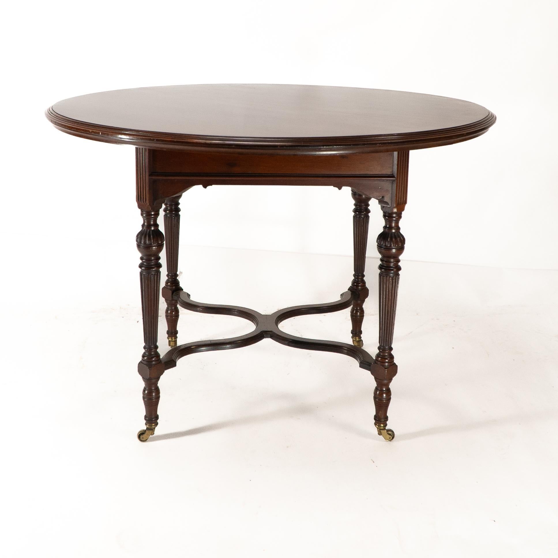 English Collinson & Lock attributed. An Aesthetic Movement walnut circular center table For Sale