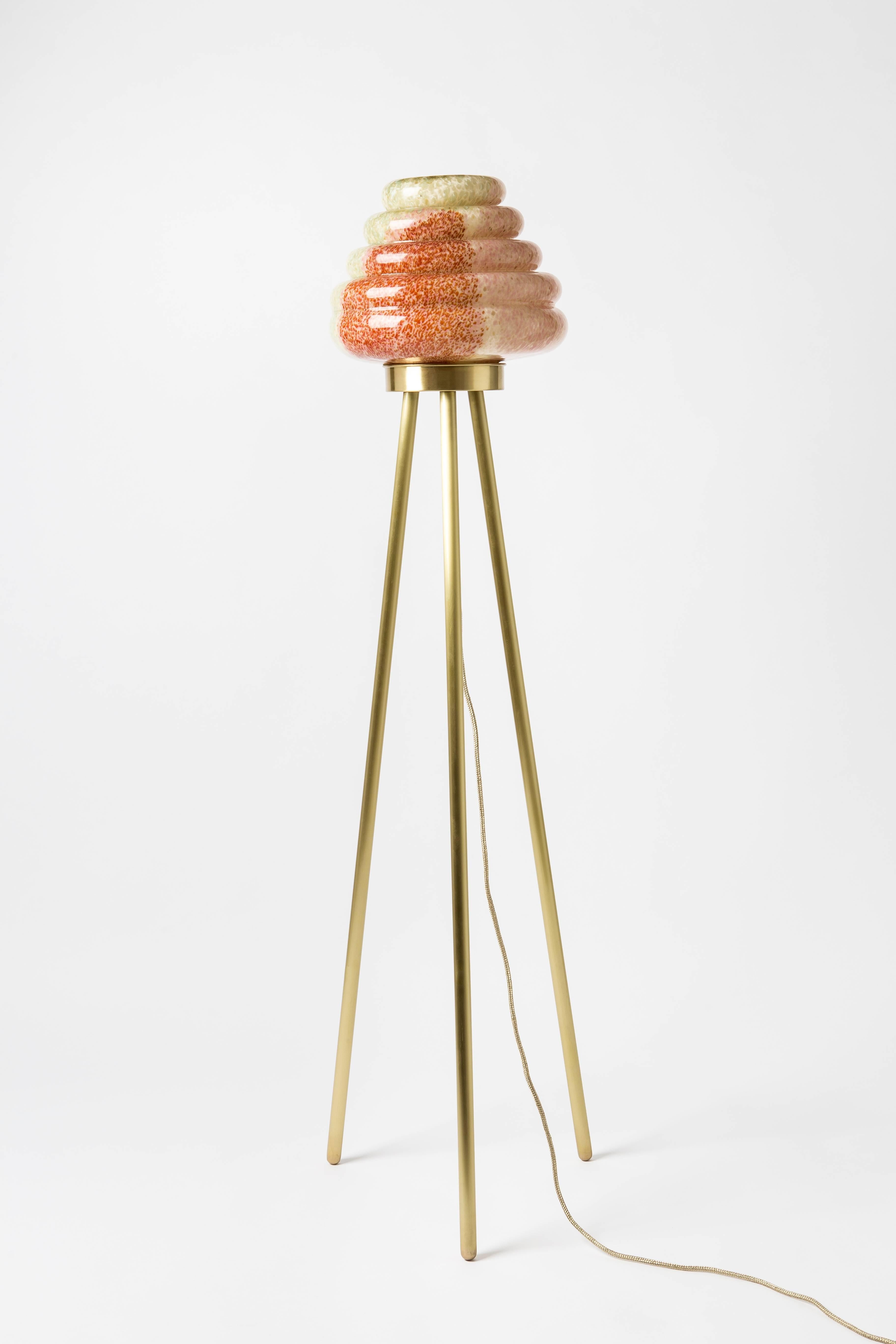 From esteemed Turkish designer, Merve Kahraman comes the elegant Colmena floor lamp.

This beehive inspired floor lamp comprises a dotted pattern handblown glass shade and matte brass legs 

A second version of Colmena has the mixed colored