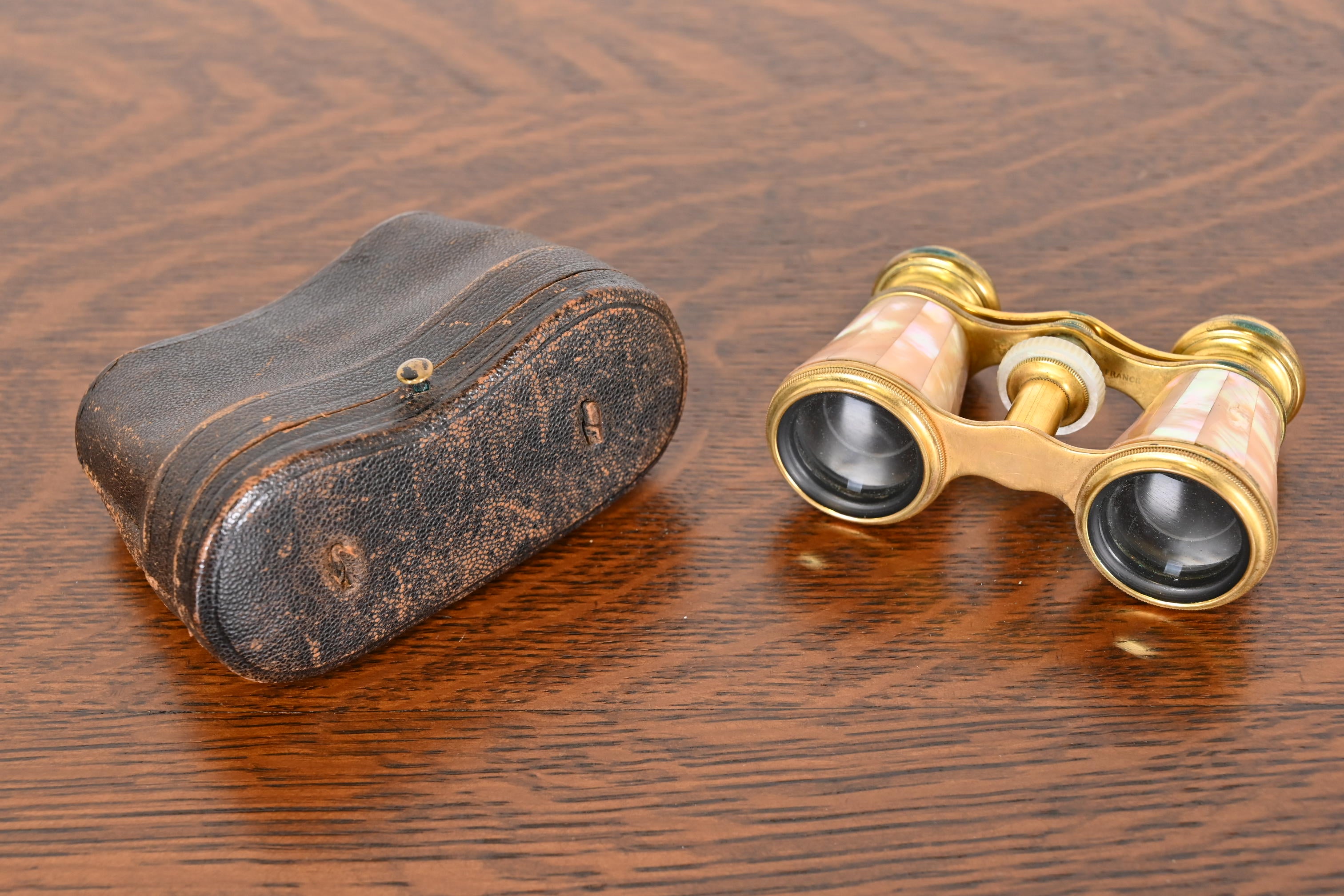 A stunning set of opera or theatre glasses in original leather case.

By Colmont FT Paris

France, Circa 1890s

Gorgeous Mother-of-pearl and abalone inset on brass cylindrical body with glass ocular lenses.
Case comprised of genuine leather with