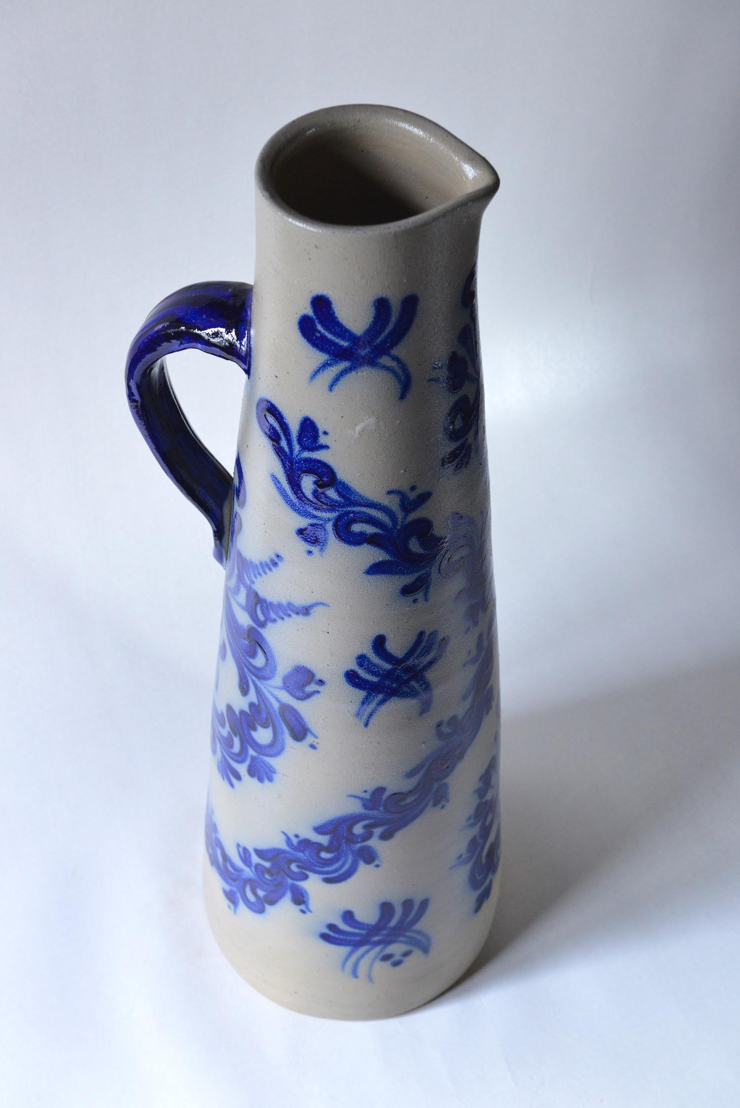 Blue and grey glazed oversized art deco jug from Cologne, circa 1920.
The blue and grey glazed stoneware pots are a tradition in Cologne since the 17th century. They have that typical grey blue and cobalt blue decorations. Originally, they were