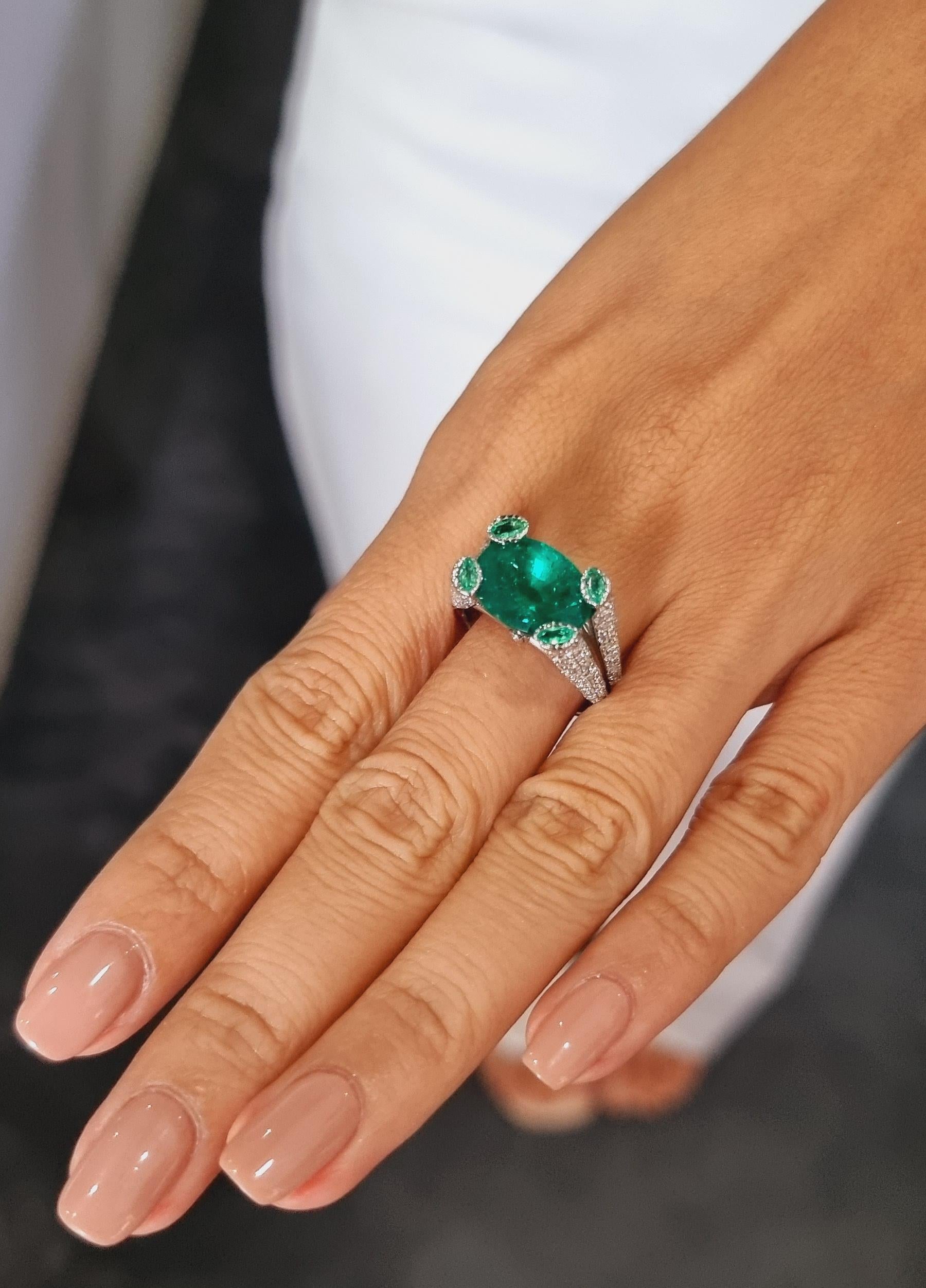 A truly special kind of a ring.

Presenting an exquisite masterpiece, a truly unique and opulent ring adorned with a certified 5.50-carat oval Colombian emerald of unparalleled quality, certified by GRS. This captivating gem, possessing a rich and