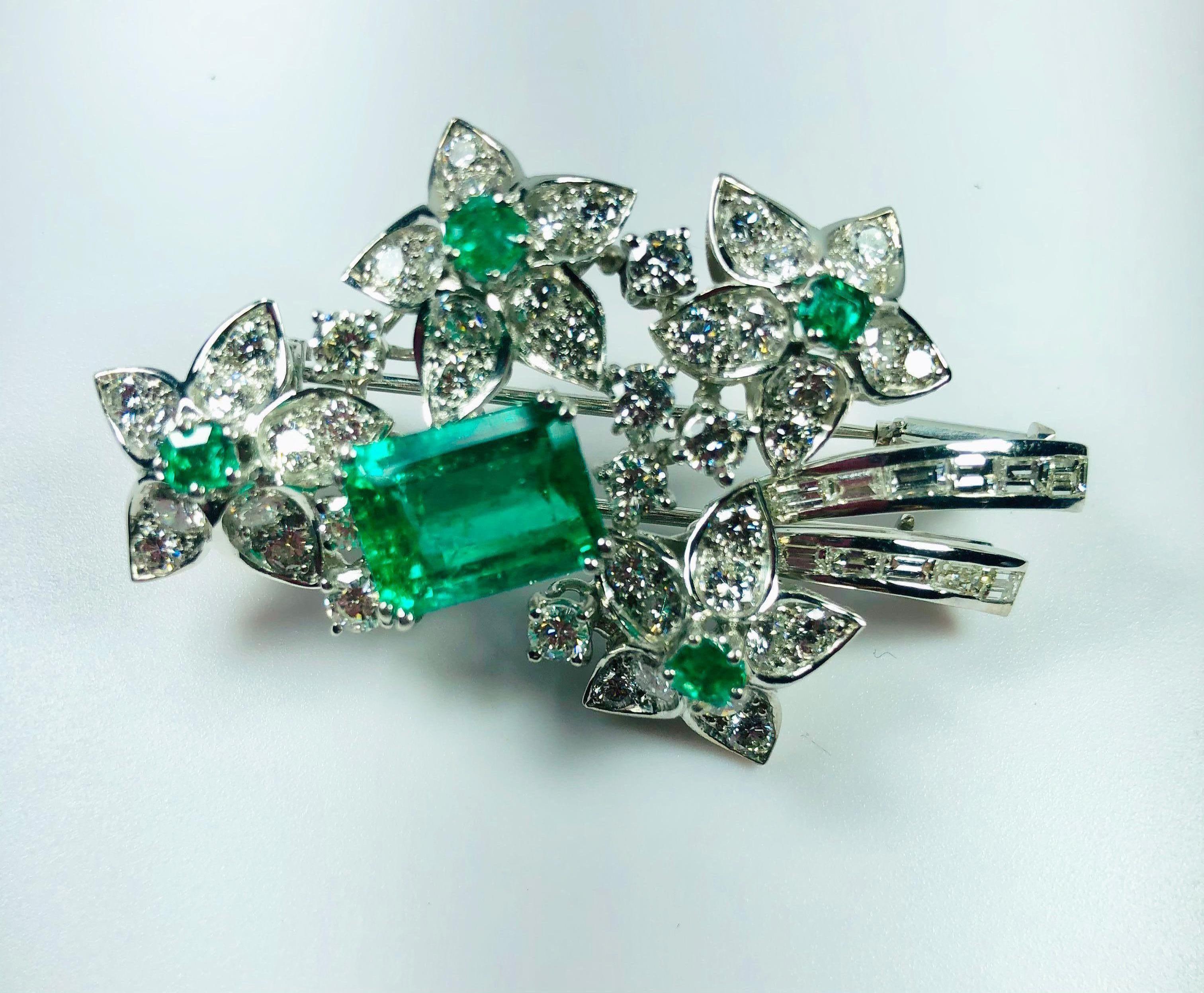 
Beautiful Flower Brooche Colombian Emerald shape Emerald
A remarkable deep transparent green 7.44 ct Colombian emerald
Emerald size: 13.18 x 10.37 x 6.73 mm.

MATERIALS
◘ Weight 24 grams 
◘ Size Broche 52cm / 20,47inches
◘ Baguettes and brilliant 