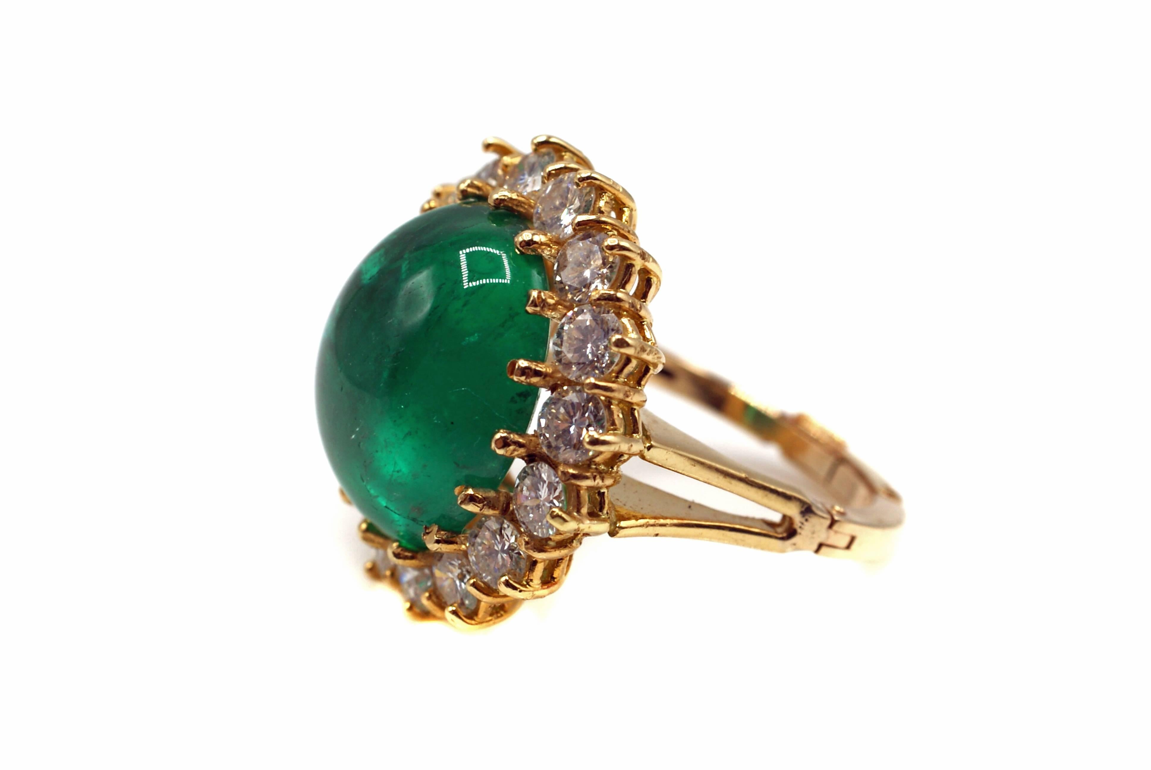 Amazing forest green Colombian cabochon emerald and diamond gold ring. The perfectly cut oval cabochon is accompanied by a report from the AGL ( American Gemological Laboratory ) which states that the origin is Colombia and the treatment is minor