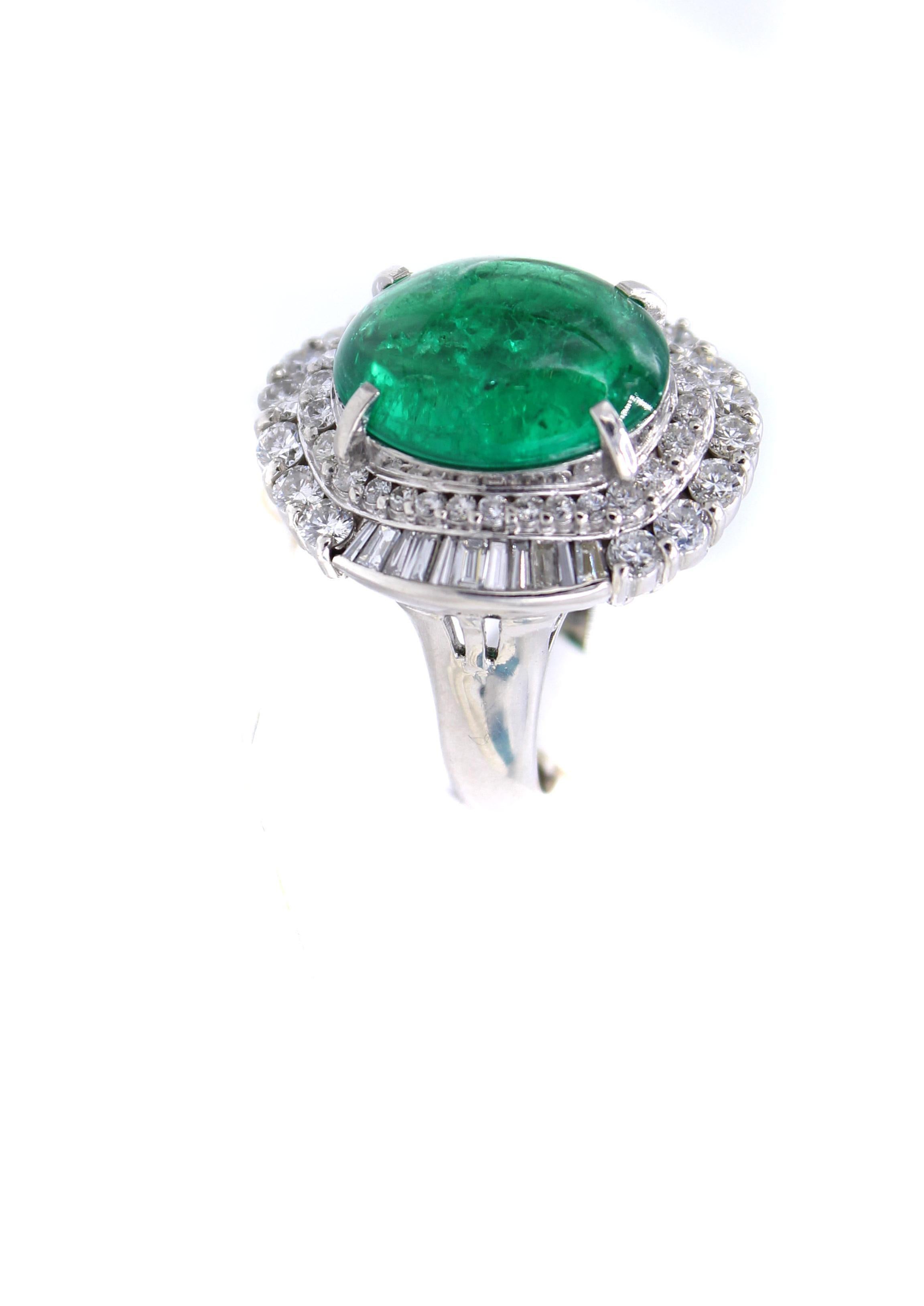 A luscious forest green cabochon emerald weighing 5.01 carats is the centerpiece of this bold platinum 1970s ring. The emerald comes with a report from the AGL. Embellishing the center gem are beautifully matched bright white round brilliant cut and