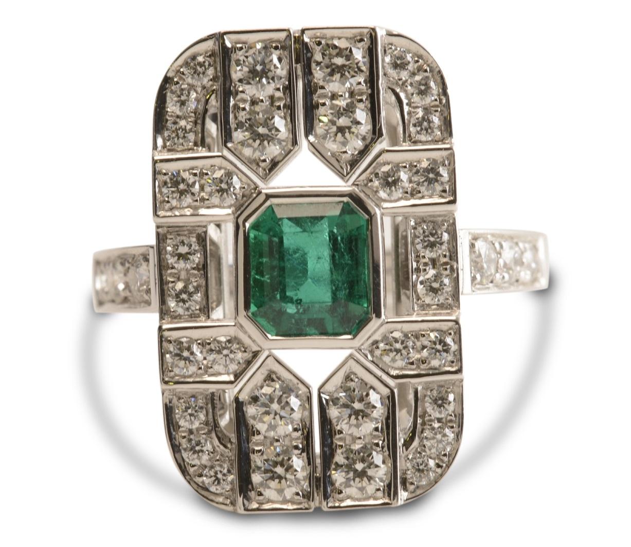 Nicky Burles has long been inspired by Art Deco fine jewellery, this beautiful, handmade, 18 karat white gold tablet ring pays homage to this classic movement. A natural emerald cut emerald of 1.28 carats floats in a fine bezel setting surrounded by