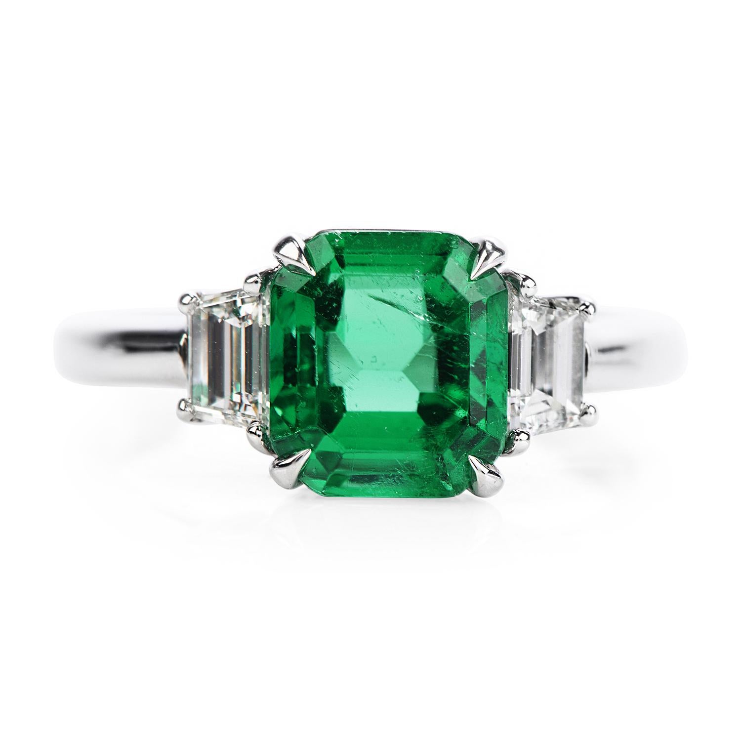 Deep green minor enhanced AGL Certified Colombian Emerald & Diamond engagement ring.

Crafted in solid platinum, the center is adorned by an Incredible AGL-certified Colombian Emerald with minor coating treatment, emerald cut, prong set, weighing