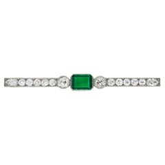 Colombian emerald and diamond bar brooch, circa 1920.
