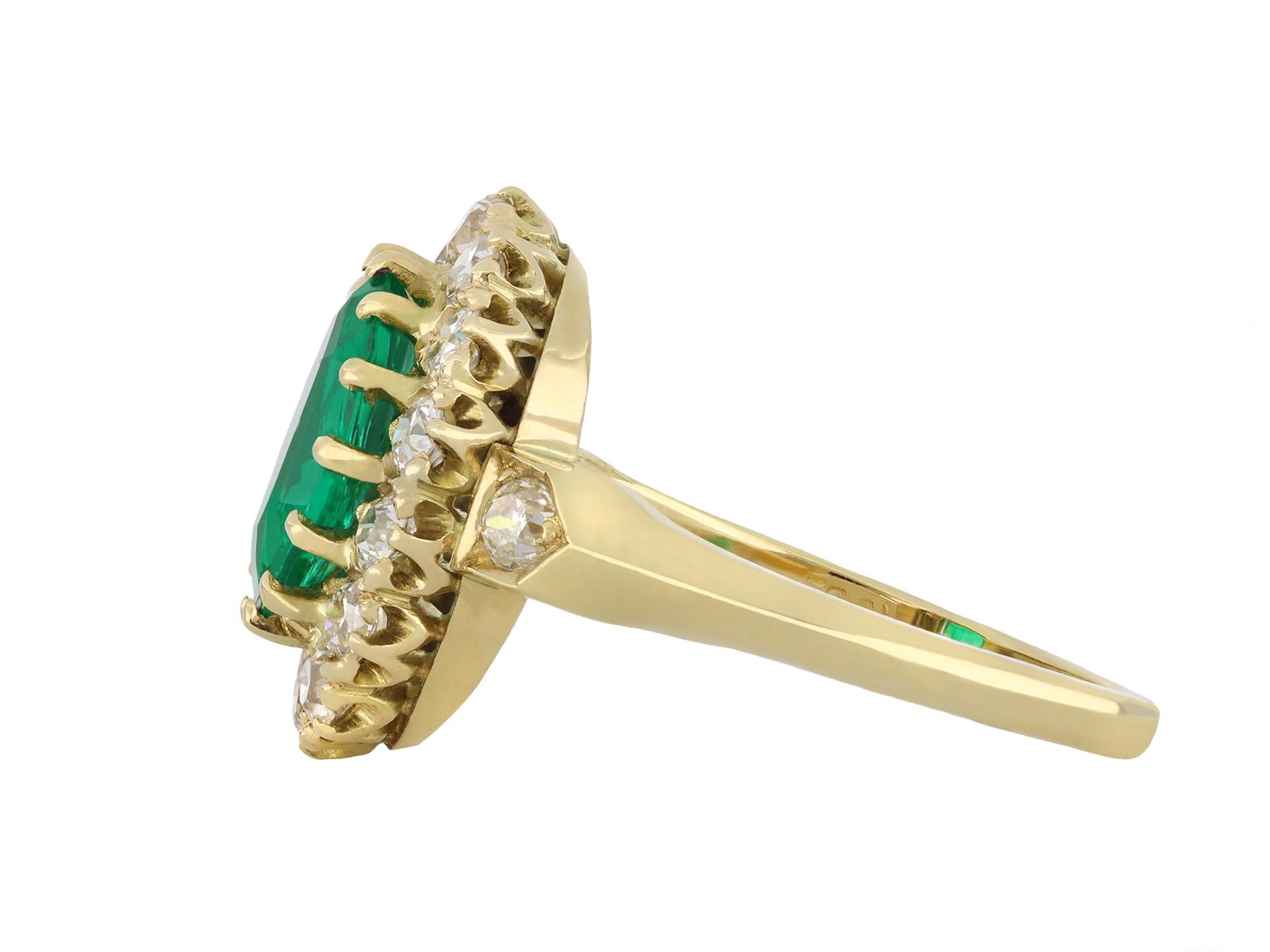 No Oil Colombian emerald and diamond coronet cluster ring. Set to centre with an oval step cut natural Colombian emerald with no oil, in an open back claw setting with an approximate weight of 1.40 carats, further set with sixteen cushion shape old