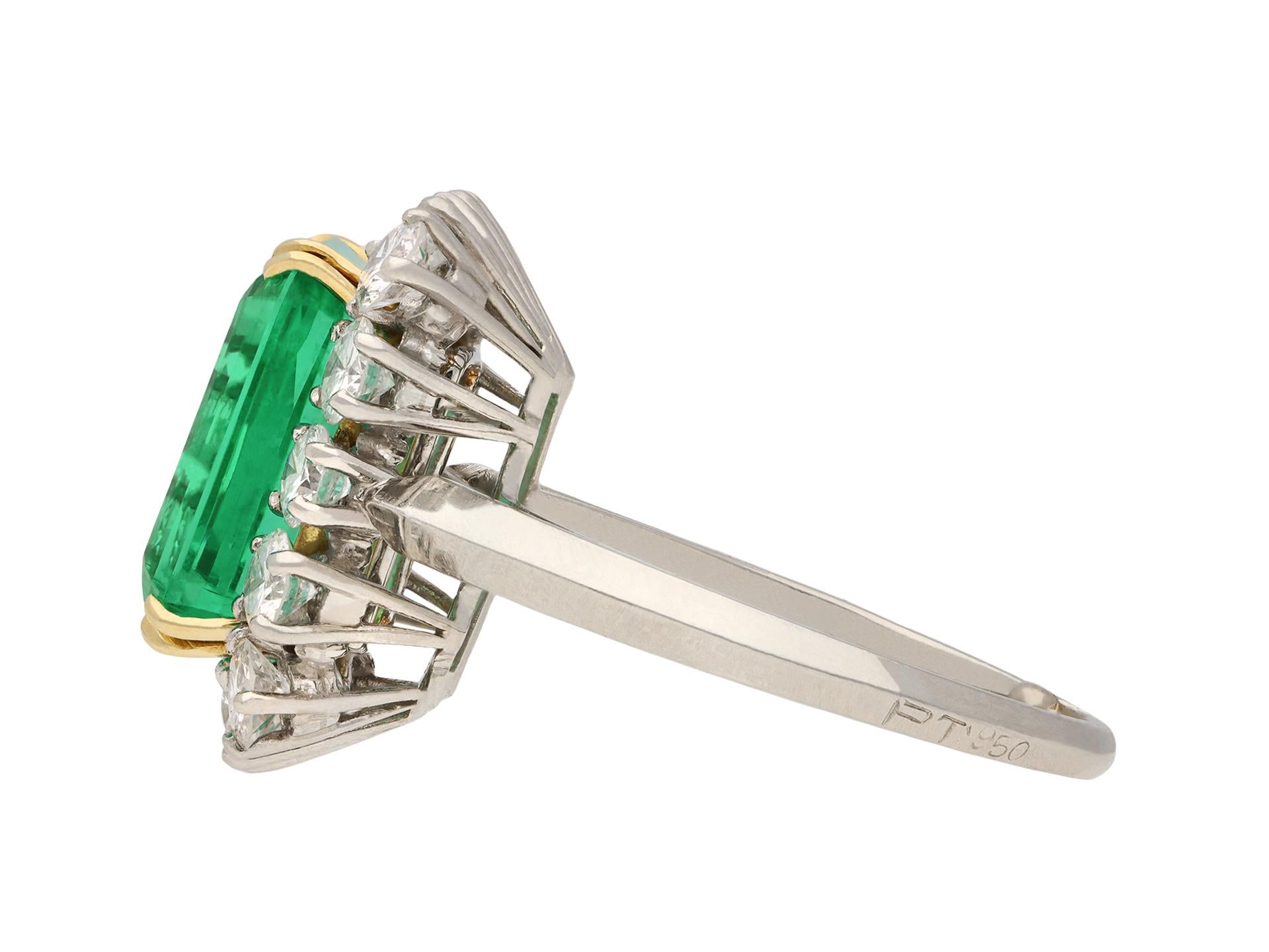 Colombian emerald and diamond coronet cluster ring. Set to centre with an octagonal emerald-cut natural Colombian emerald with minor clarity enhancement in an open back claw setting with an approximate weight of 5.27 carats, encircled by fourteen