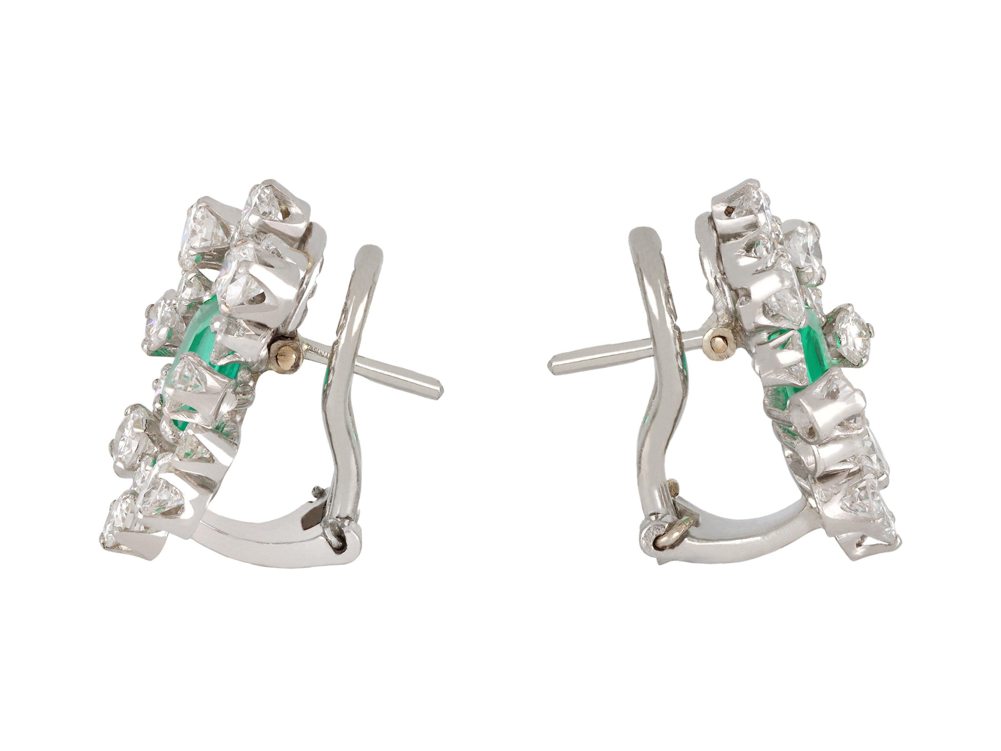 Colombian emerald and diamond earrings. A matching pair, each set to centre with one octagonal emerald-cut natural Colombian emerald with insignificant indications of clarity enhancement in an open back claw setting, two in total, with a combined