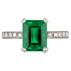Antique Colombian emerald and diamond flank solitaire ring, circa 1925