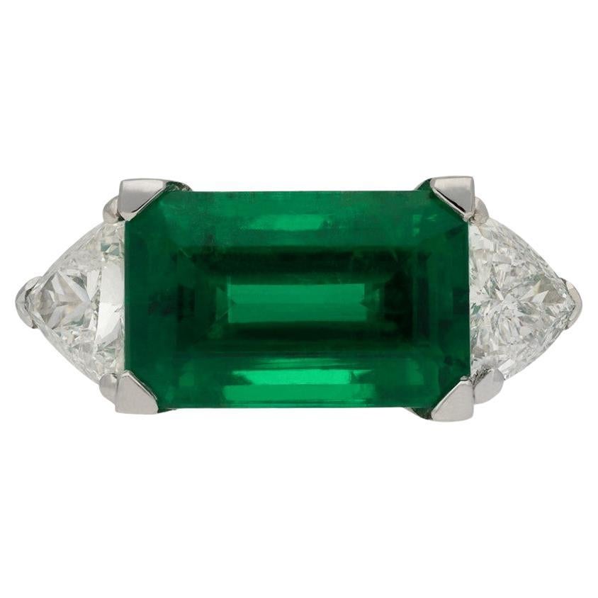 Colombian Emerald and Diamond Flanked Solitaire Ring For Sale