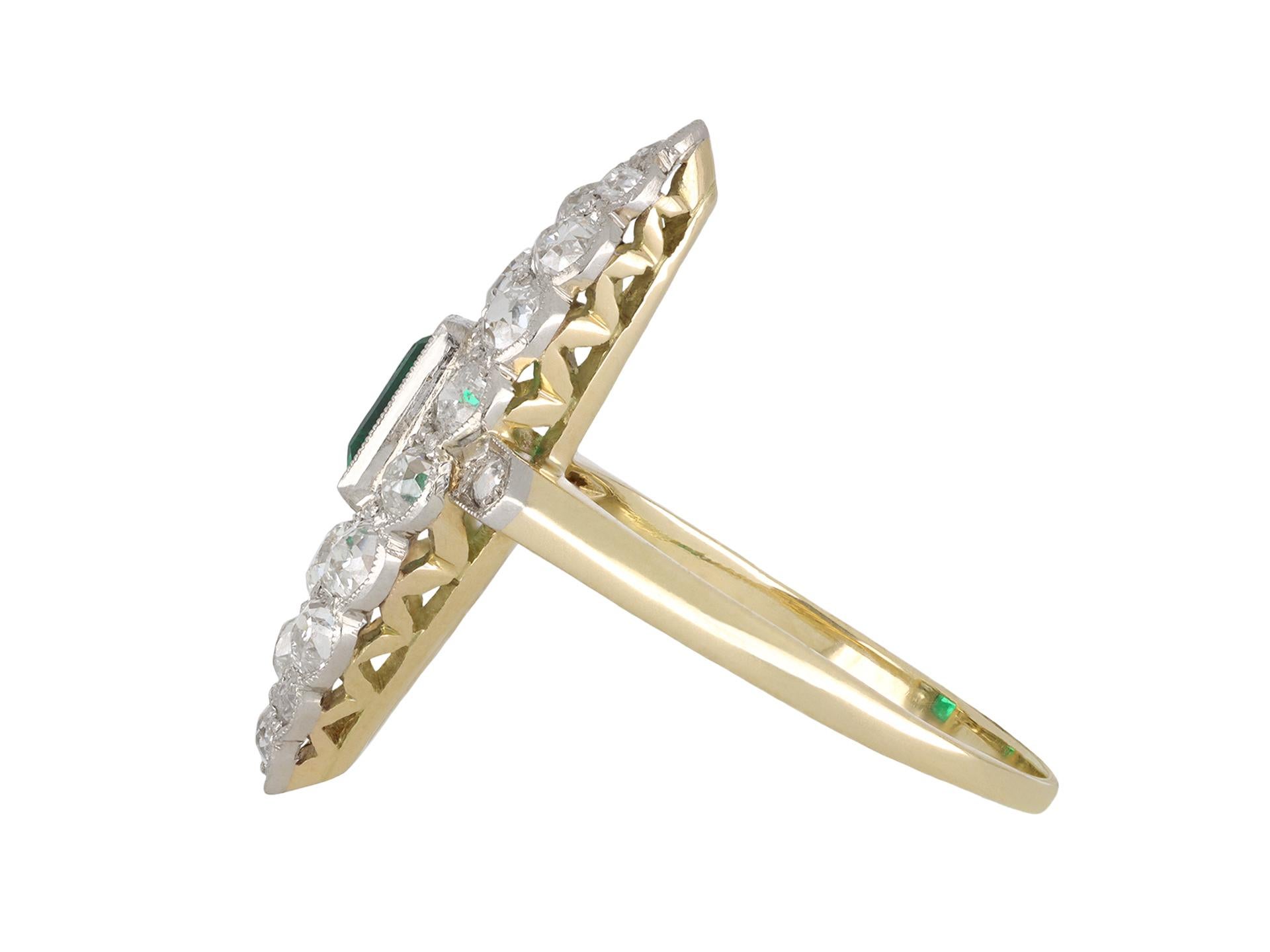 Colombian emerald and diamond marquise cluster ring. Set to centre with one rectangular step cut natural Colombian emerald with minor oil in an open back rubover setting with an approximate weight of 0.75 carats, flanked by one round old cut diamond