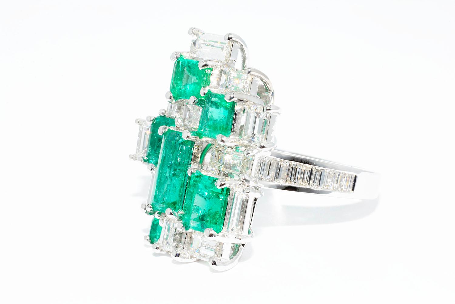 Colombian Emerald and Diamond Modern Cocktail Ring

Colombian Emeralds 6 pieces Emerald cuts 2.65 ct
Baguette Diamonds 29 pieces 2.50 ct  F VS1
18K White Gold
Finger Size 6.75
